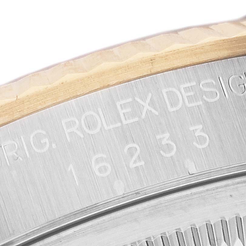 This close-up image shows the engraved text and model number "16233" on the caseback edge of a Rolex Datejust 16233 Men's Steel and Gold (two tone) Black Dial 16233 Men's Steel and Gold (two tone) Black Dial watch.