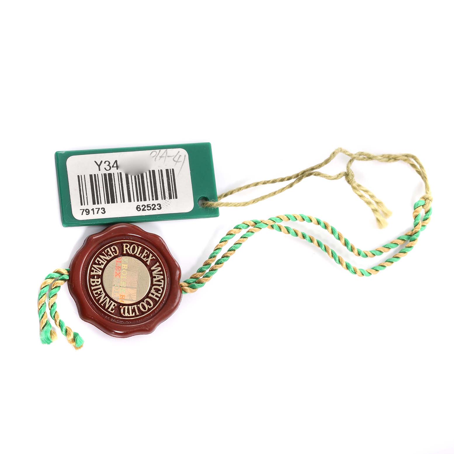 The image shows a Rolex Datejust 79173 Women's Steel and Gold (two tone) Champagne Dial watch accessory, featuring a green tag and a red seal with a braided cord.