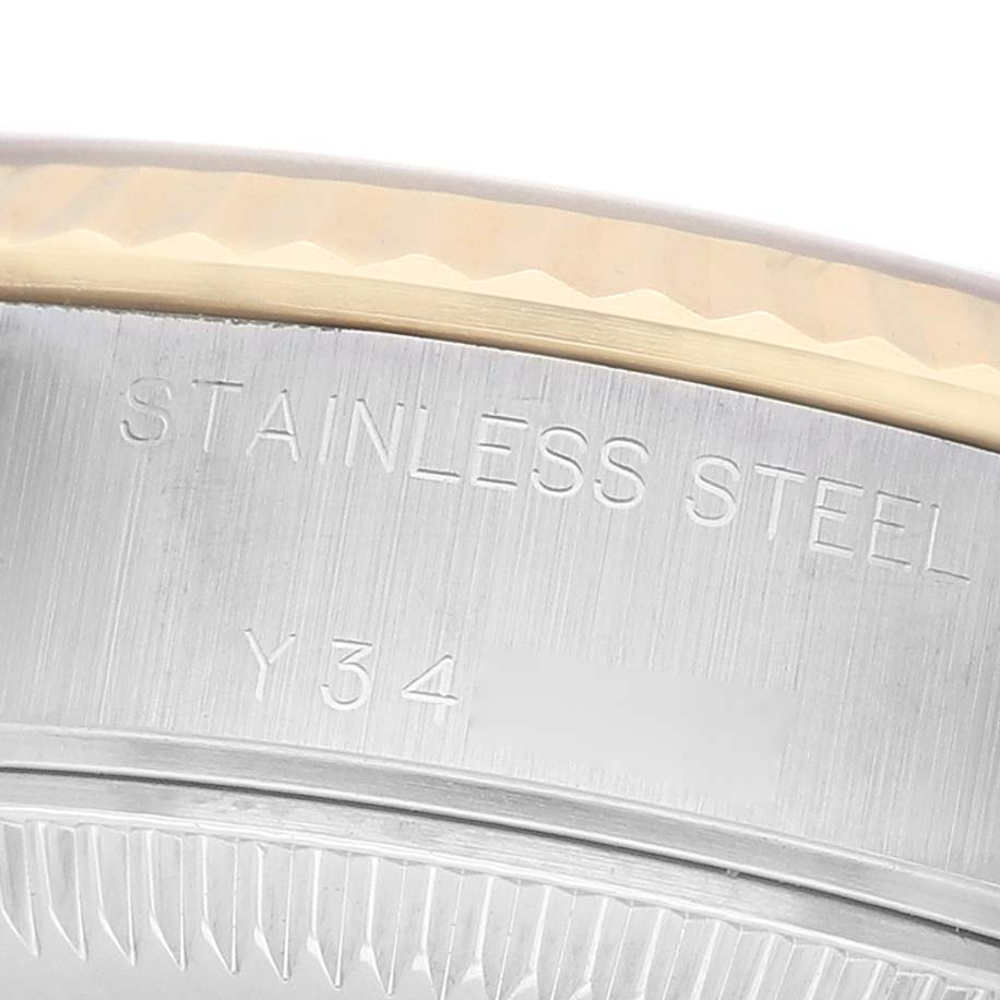 The image shows a close-up of the bezel and case edge of a Rolex Datejust 79173 Women's Steel and Gold (two tone) Champagne Dial, highlighting the material engraving.