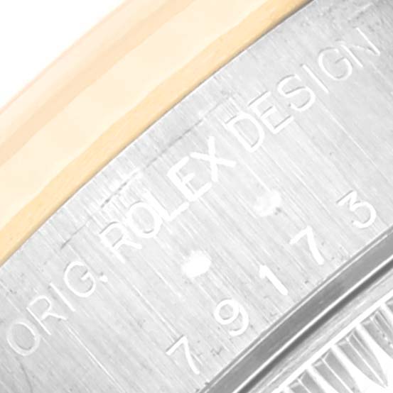 This image shows a close-up view of the engraved watch case back of a Rolex Datejust 79173 Women's Steel and Gold (two tone) Champagne Dial 79173 Women's Steel and Gold (two tone) Champagne Dial.