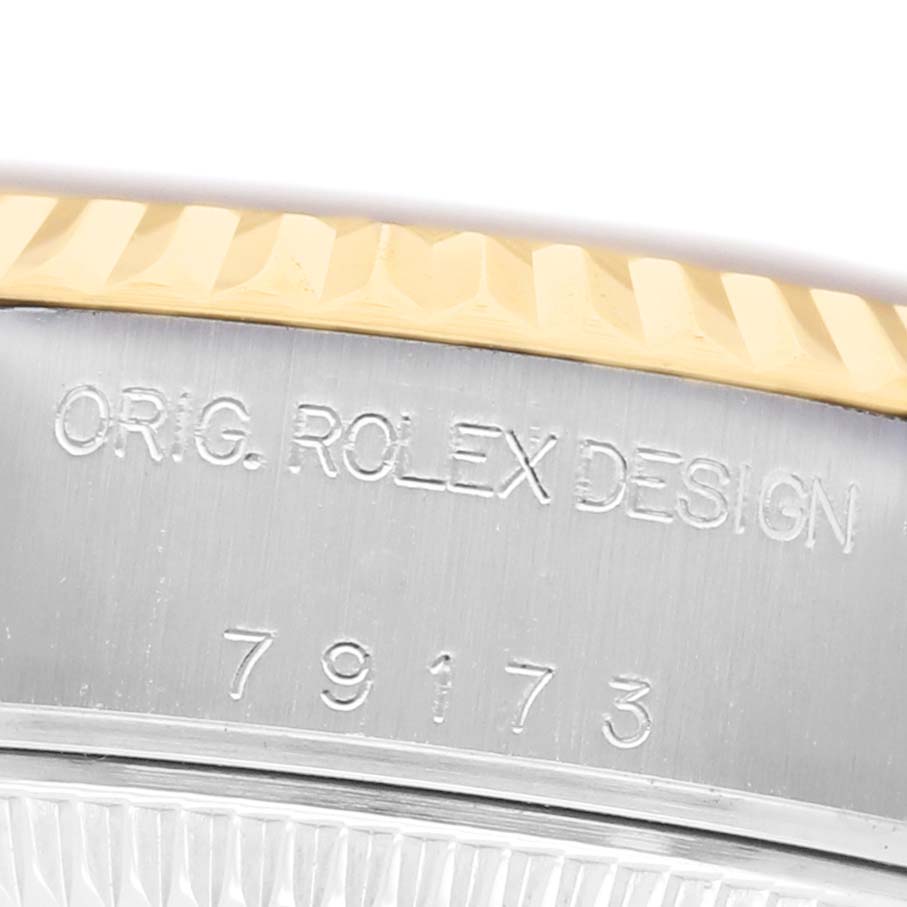 The image shows a close-up of the side of a Rolex Datejust 79173 Women's Steel and Gold (two tone) Champagne Dial, highlighting the engraved model number and "Orig. Rolex Design" inscription.