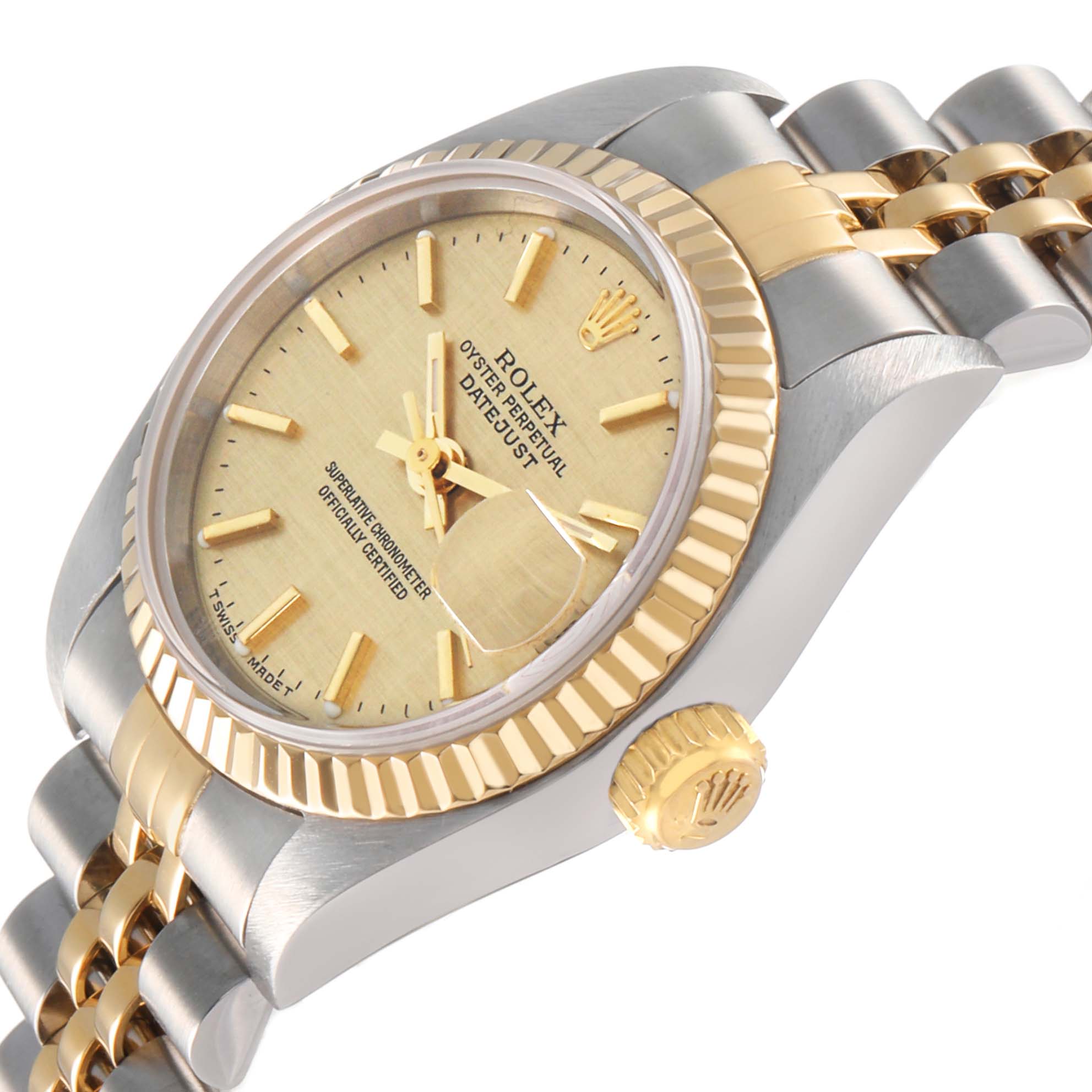 The Rolex Datejust 79173 Women's Steel and Gold (two tone) Champagne Dial watch is shown from a diagonal angle, highlighting the dial, fluted bezel, and jubilee bracelet.