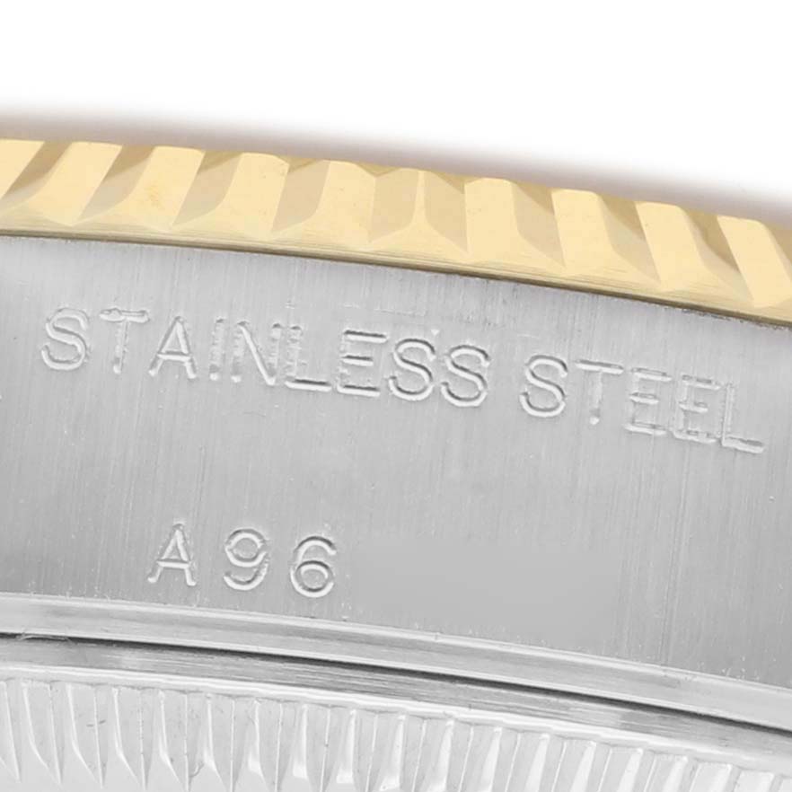 The image shows a close-up of the stainless steel case back and fluted bezel of a Rolex Datejust 79173 Women's Steel and Gold (two tone) Champagne Dial watch.