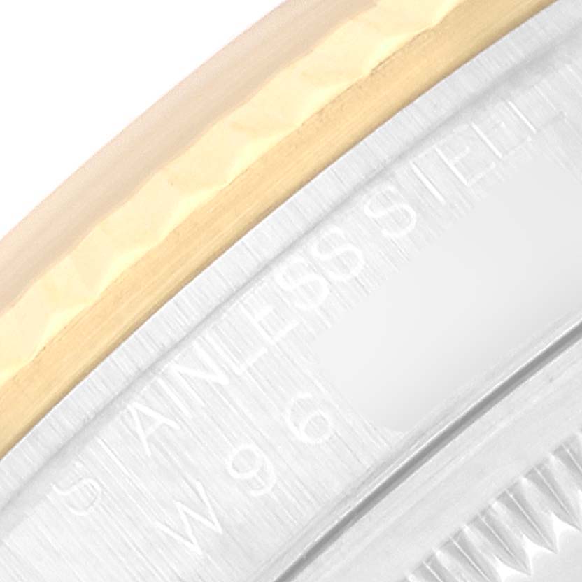 This close-up image shows part of the bezel and the inner rim of the Rolex Datejust 16233 Men's Steel and Gold (two tone) Champagne Dial 16233 Men's Steel and Gold (two tone) Champagne Dial watch, displaying "STAINLESS STEEL" engraving.