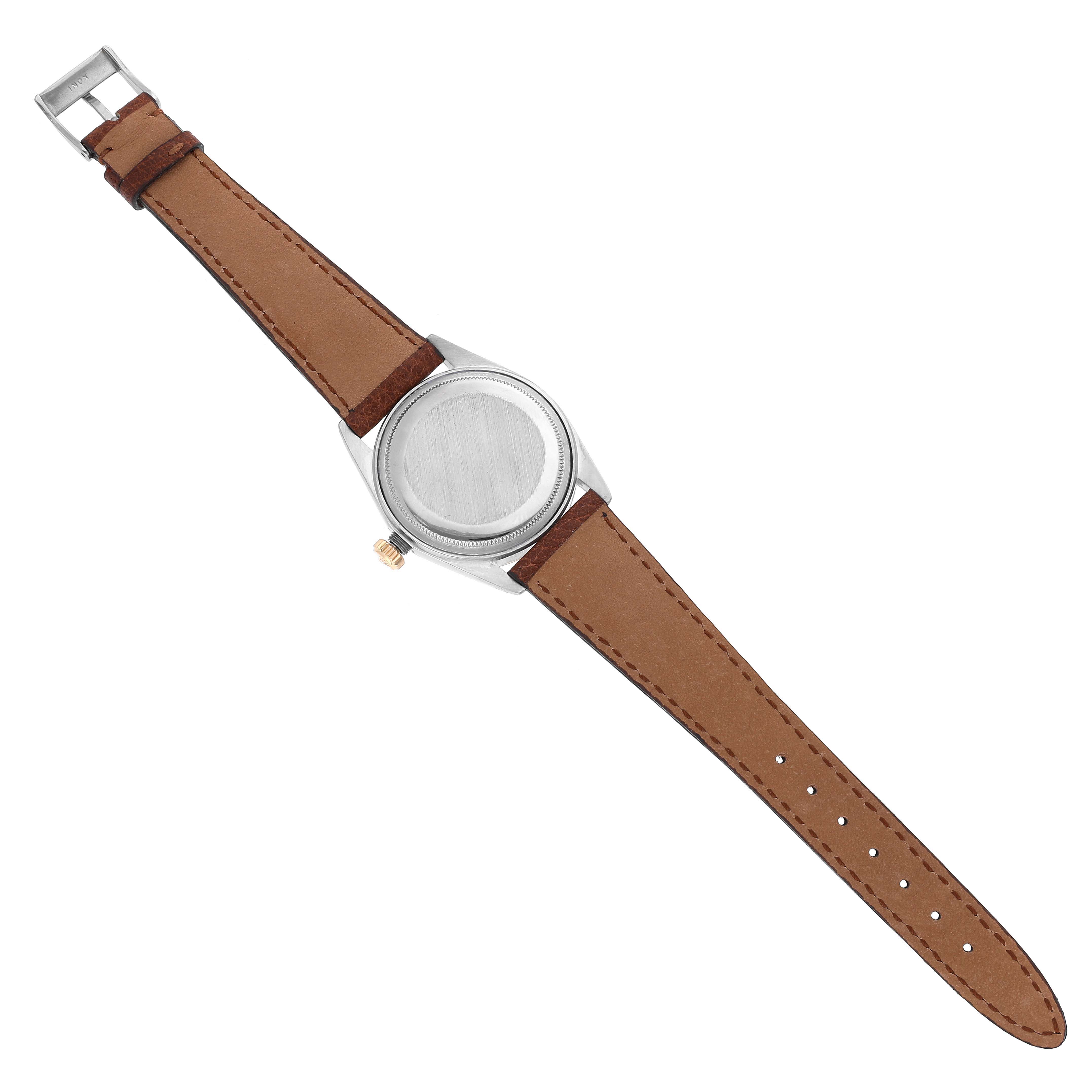 The image shows a Rolex Vintage Collection 1601 Men's Steel and Gold (two tone) Silver Dial 1601 Men's Steel and Gold (two tone) Silver Dial model watch viewed from the back, highlighting its brown leather strap and case back.