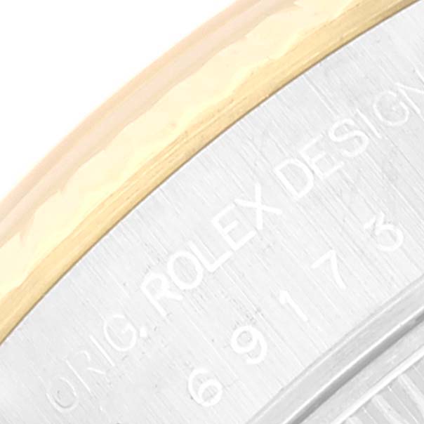 This close-up image shows the engraved text and part of the bezel of a Rolex Datejust 69173 Women's Steel and Gold (two tone) White Dial 69173 Women's Steel and Gold (two tone) White Dial watch.