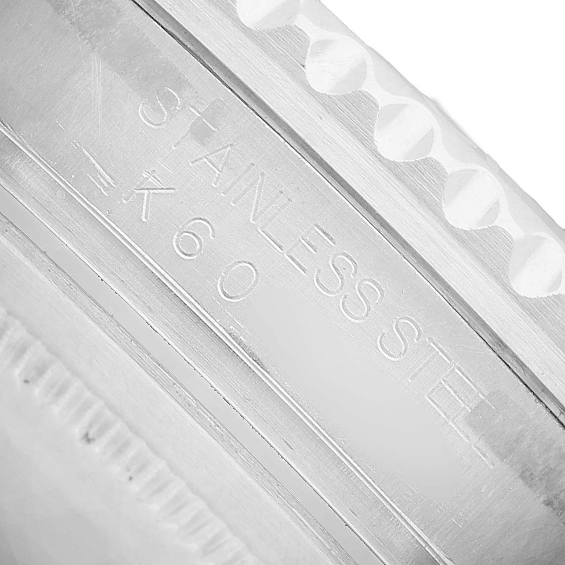 The image shows a close-up of the bezel and side of a Rolex GMT-Master 16710 Men's Stainless Steel Black Dial watch, highlighting the "STAINLESS STEEL" engraving.