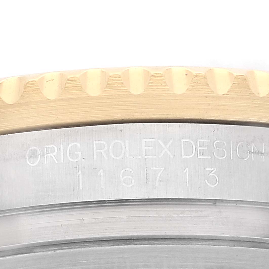 This image shows a close-up of the case side of the Rolex GMT-Master 116713 Men's Steel and Gold (two tone) Black Dial 116713 Men's Steel and Gold (two tone) Black Dial, highlighting the "ORIG. ROLEX DESIGN 116713" engraving.