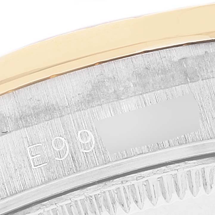 This image shows a close-up of the serial number on the side of the bezel of a Rolex President 68289 Women's Steel and Gold (two tone) Brown Dial 68289 Women's Steel and Gold (two tone) Brown Dial model watch.