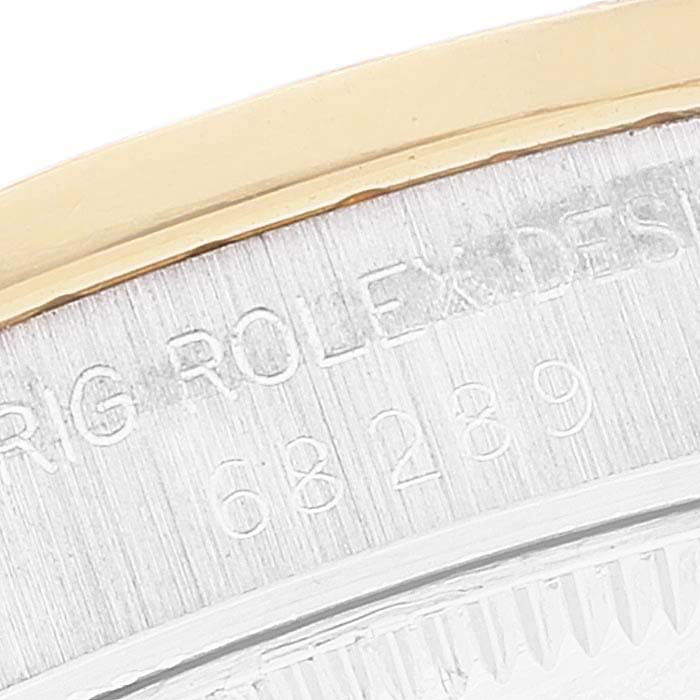 This close-up image shows the side engraving and part of the bezel on a Rolex President 68289 Women's Steel and Gold (two tone) Brown Dial 68289 Women's Steel and Gold (two tone) Brown Dial model watch.