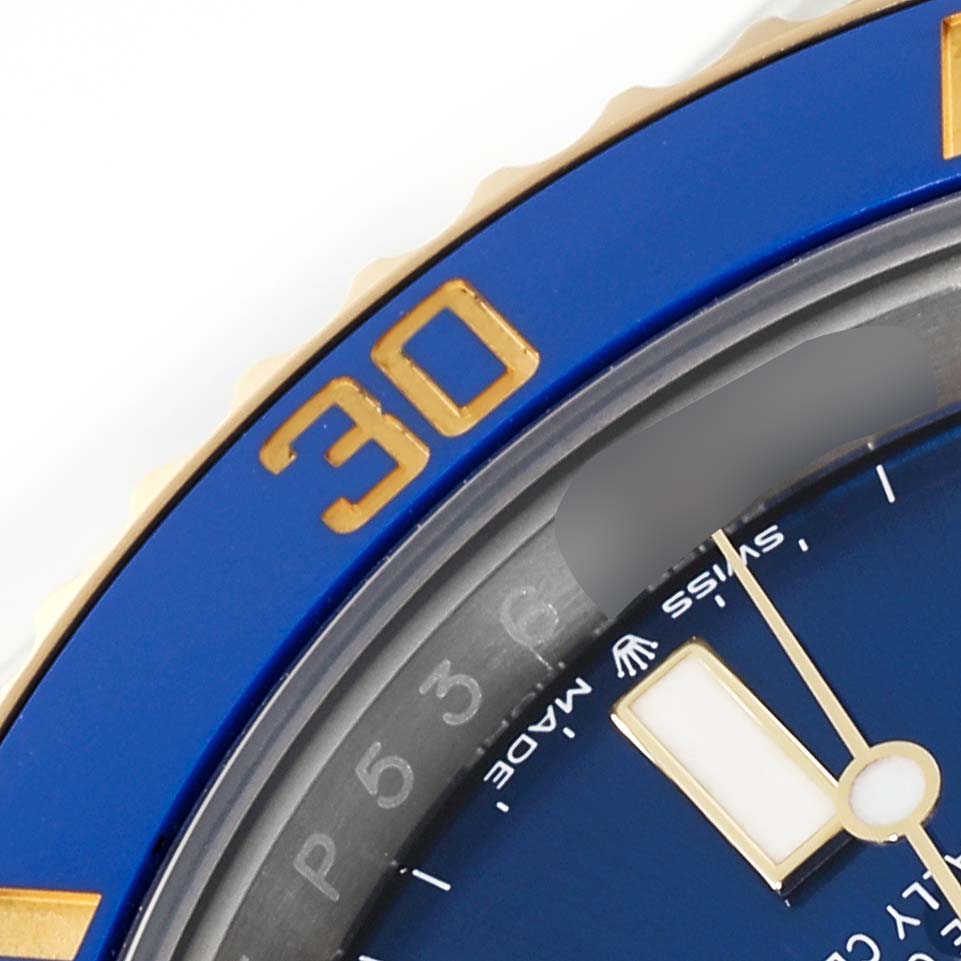 The image shows a close-up of the blue bezel and part of the dial and hand of a Rolex Submariner 126613LB Men
s Steel and Gold (two tone) Blue Dial 126613LB Men
s Steel and Gold (two tone) Blue Dial watch.