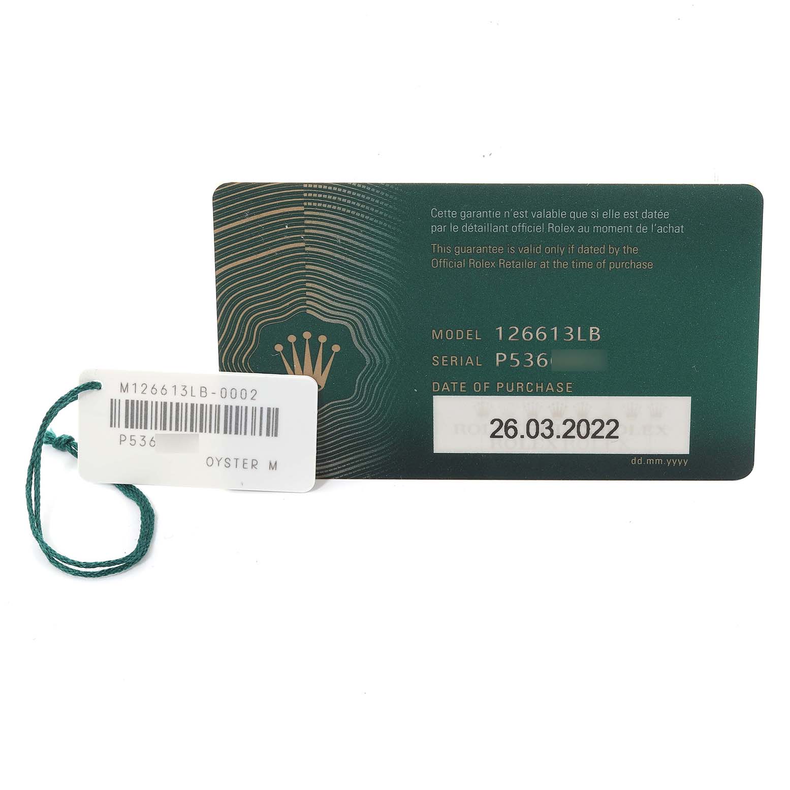 This image shows the warranty card and tag for a Rolex Submariner 126613LB Men
s Steel and Gold (two tone) Blue Dial 126613LB Men
s Steel and Gold (two tone) Blue Dial model 126613LB, dated 26.03.2022.
