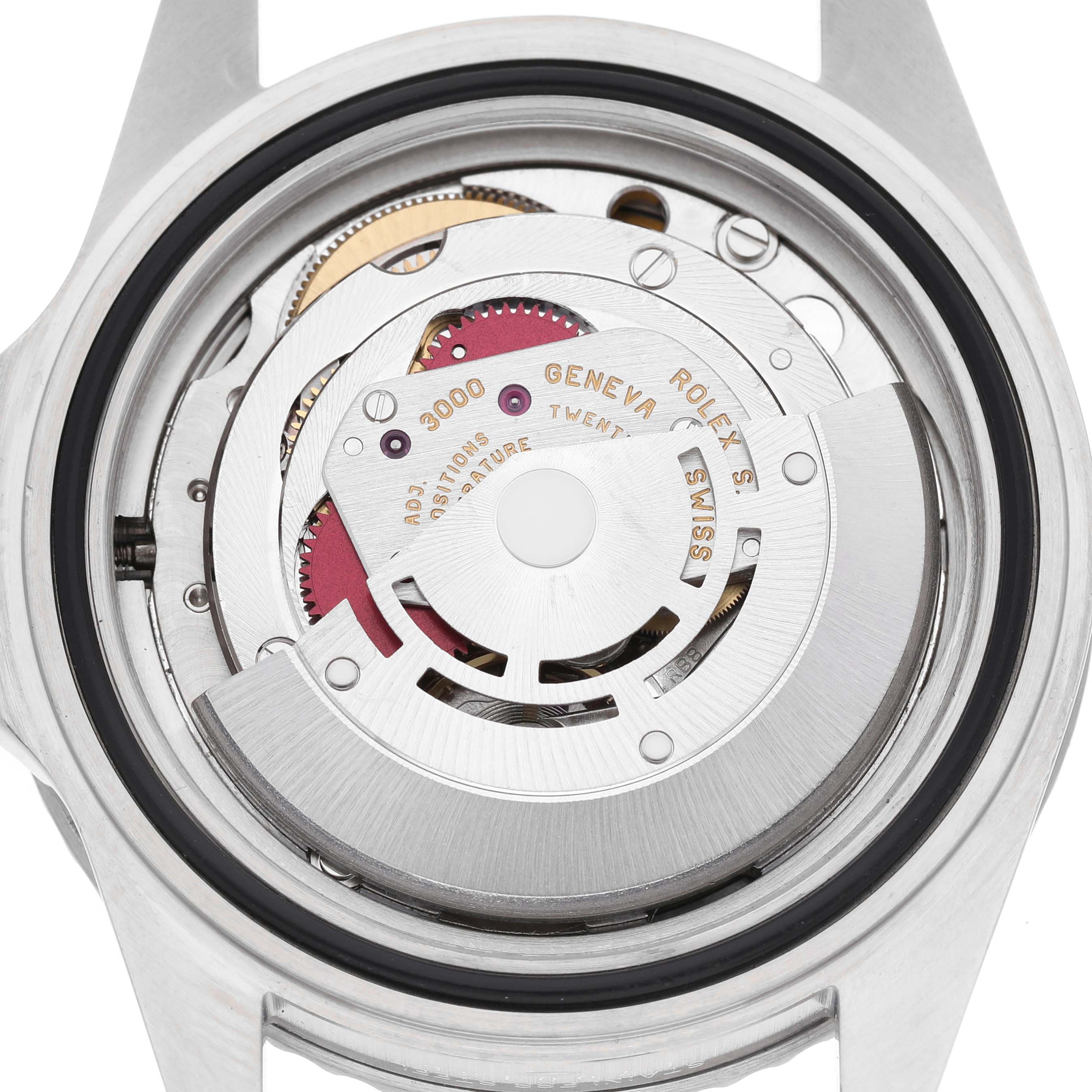 The image shows the open case back of a Rolex Submariner 14060 Men's Stainless Steel Black Dial, highlighting its movement mechanism from a top-down angle.