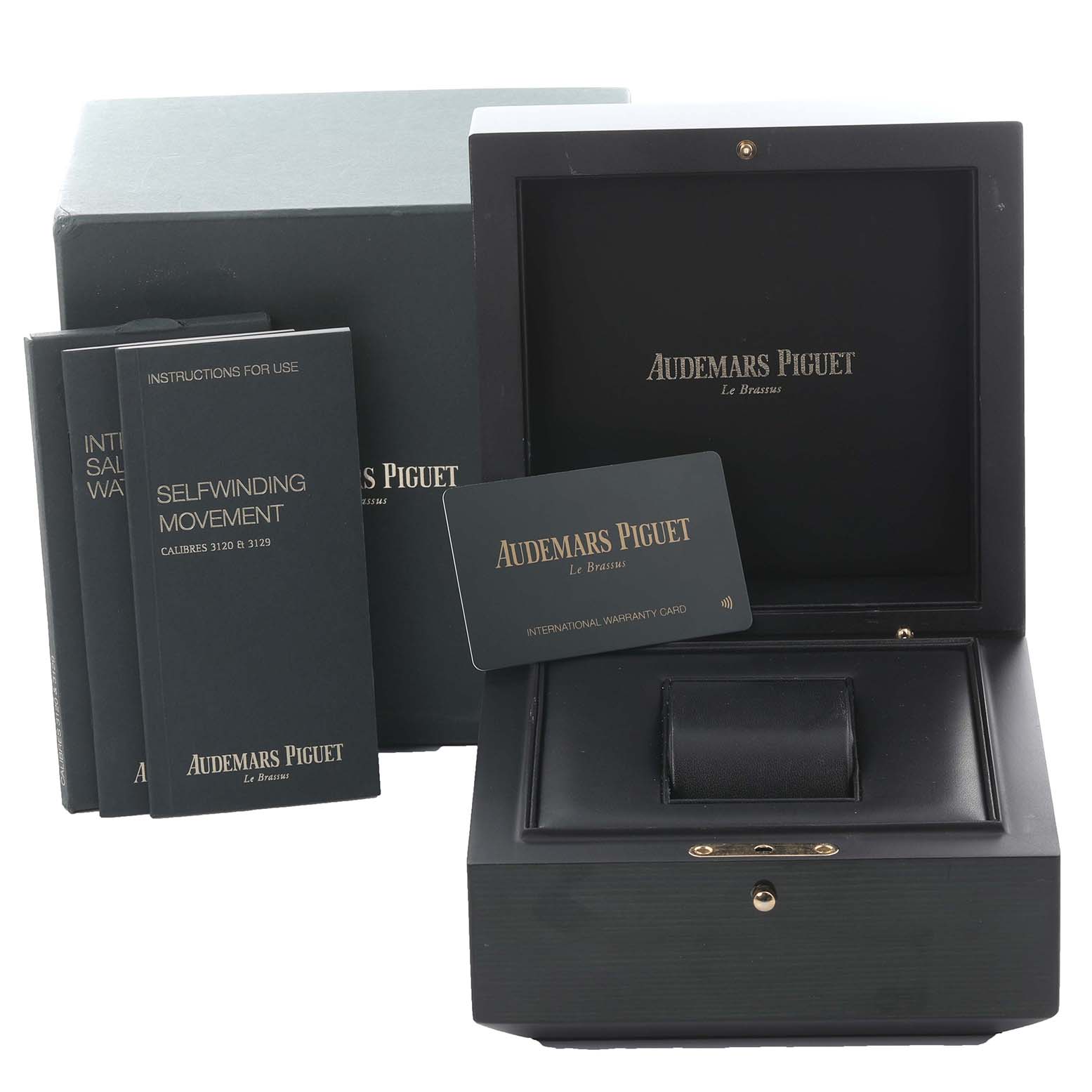 The image shows accessories of the Audemars Piguet Royal Oak 15400ST.OO.1220ST.01 Men's Stainless Steel Black Dial 15400ST.OO.1220ST.01 Men's Stainless Steel Black Dial, including a presentation box, warranty card, and instruction manuals.