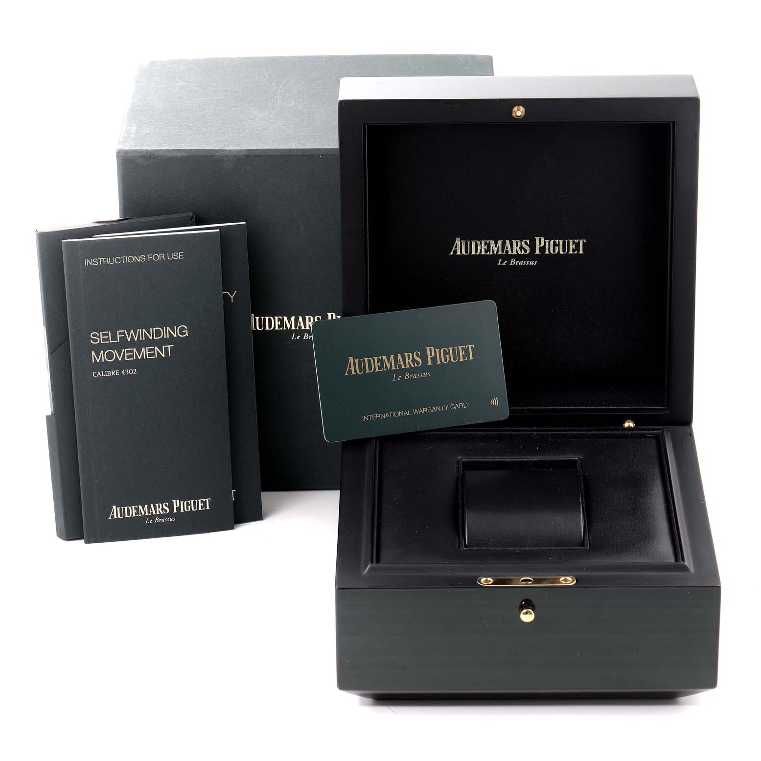 The image shows an open Audemars Piguet Royal Oak 15500ST.OO.1220ST.01 Men's Stainless Steel Blue Dial 15500ST.OO.1220ST.01 Men's Stainless Steel Blue Dial watch box, instruction manuals, and an international warranty card.