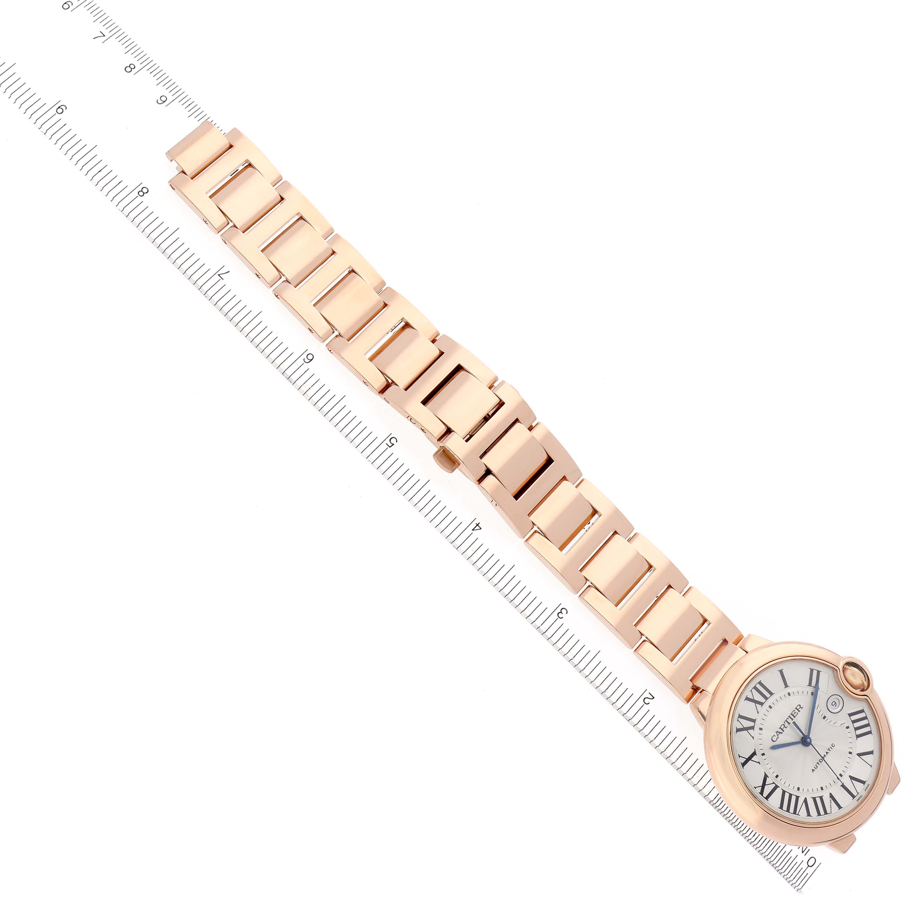 The Cartier Ballon Bleu W69006Z2 Men's Rose Gold Silver Dial W69006Z2 Men's Rose Gold Silver Dial watch is shown from a top view with its full bracelet and face visible, placed on a ruler.