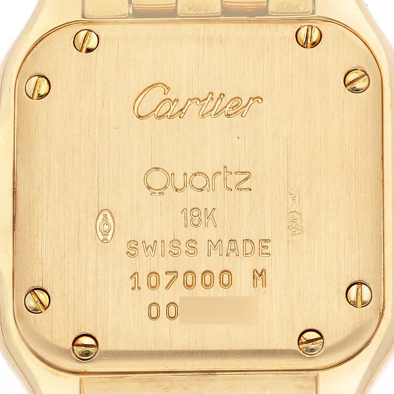 The image shows the back case of a Cartier Panthère watch, highlighting its gold tone and engraved details.