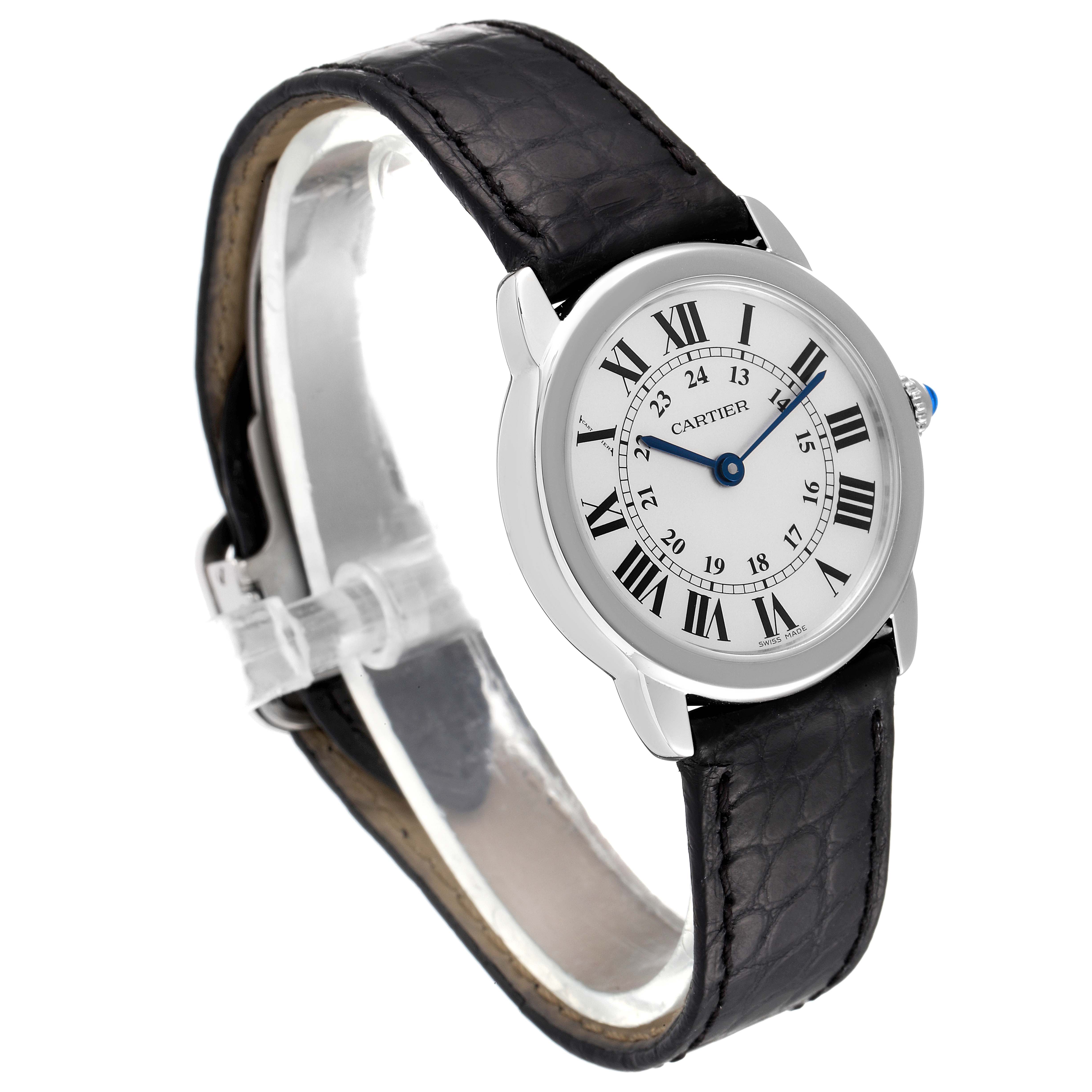 The Ronde model by Cartier is shown at a three-quarter view, highlighting its black leather strap, white dial with Roman numerals, and blue hands.
