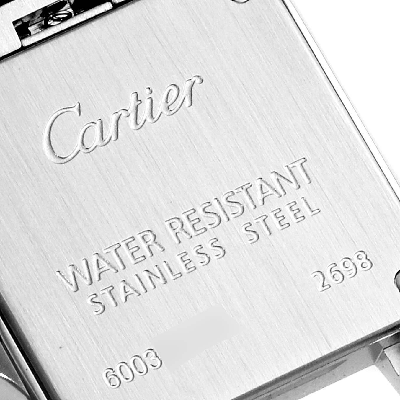 The image shows the back casing of a Cartier Santos Demoiselle W25066Z6 Women
s Stainless Steel Silver Dial W25066Z6 Women
s Stainless Steel Silver Dial watch, highlighting its water resistance and stainless steel material.