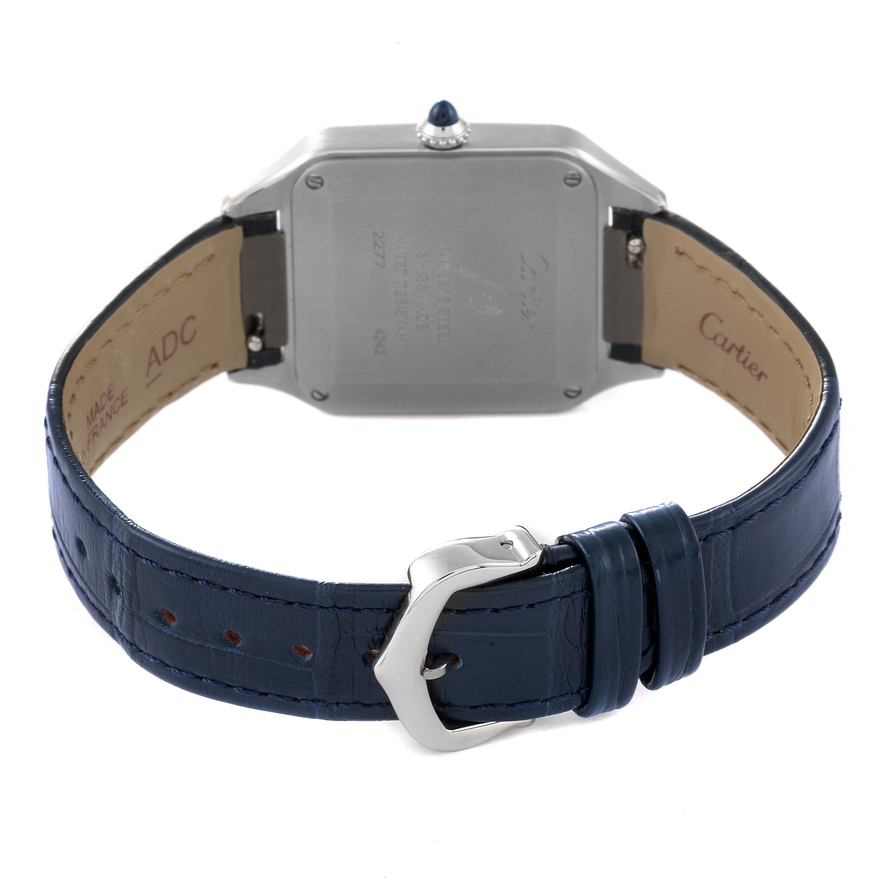 The image shows the back case and blue leather strap of a Cartier Santos WSSA0023 Women's Stainless Steel Silver Dial WSSA0023 Women's Stainless Steel Silver Dial watch, showcasing the clasp and engraving on the back.