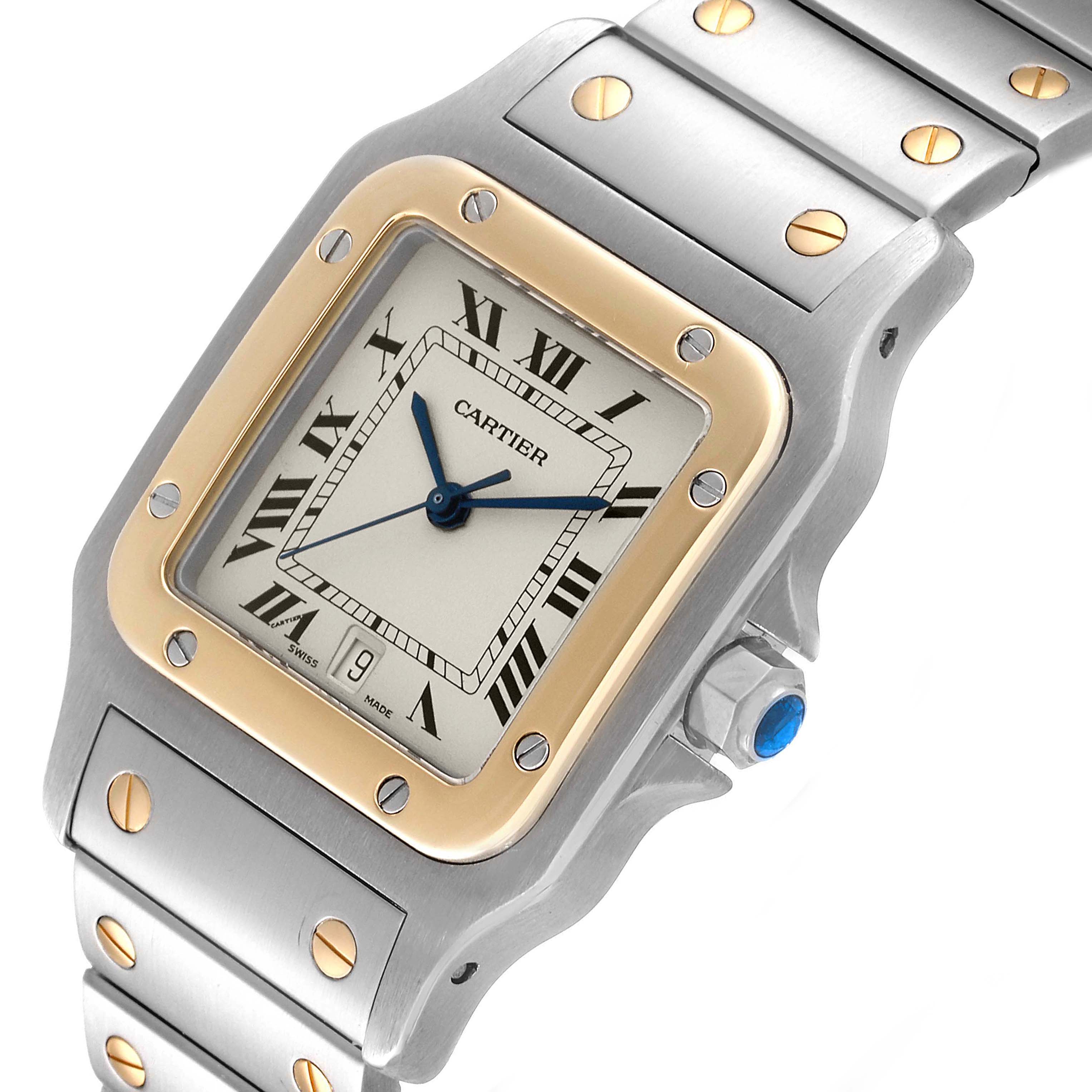 The image shows a close-up angle of the Cartier Santos 187901 Men
s Steel and Gold (two tone) Silver Dial 187901 Men
s Steel and Gold (two tone) Silver Dial watch face, including the case, bezel, and part of the bracelet.
