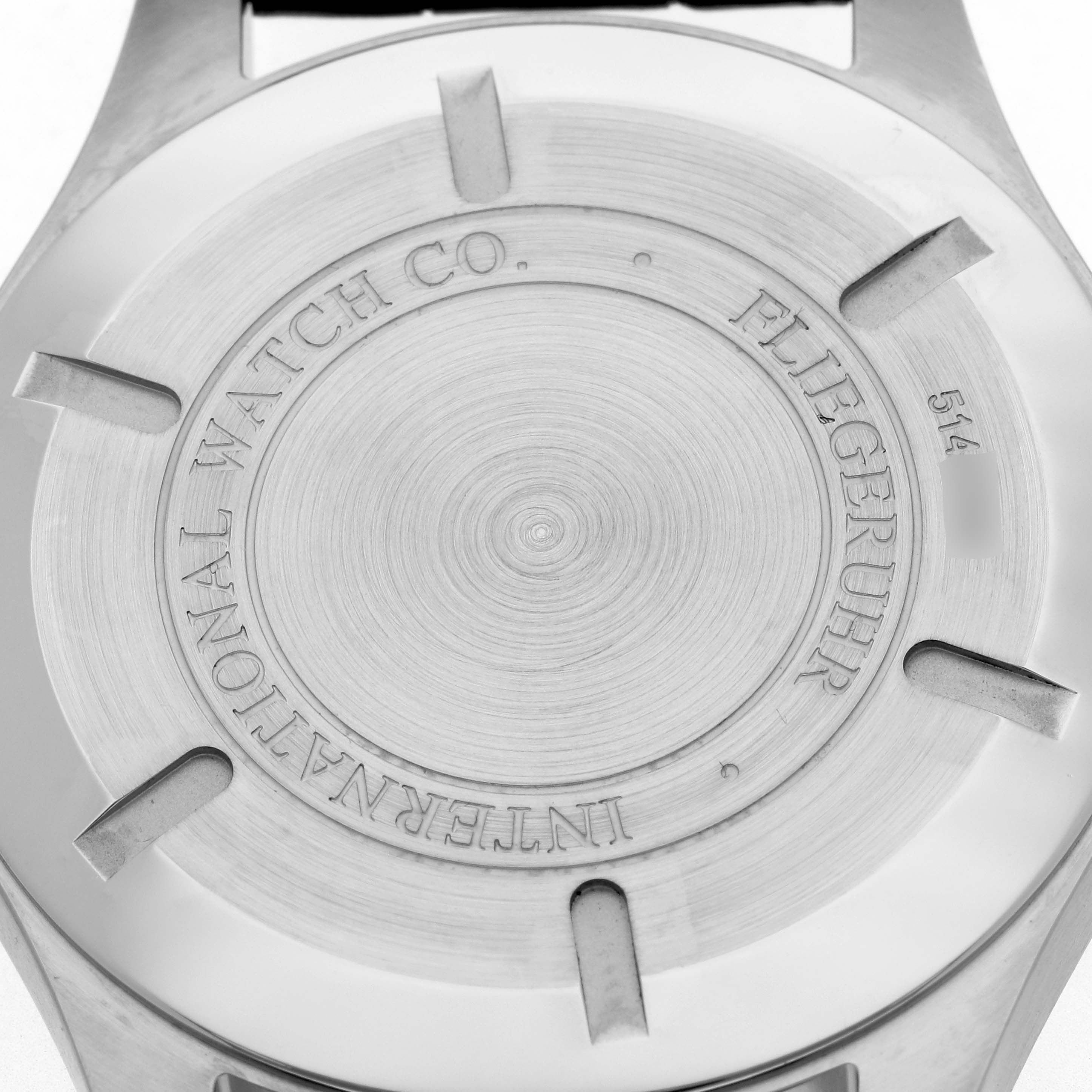 The image shows the back case of the IWC Pilot IW326501 Men's Stainless Steel Black Dial IW326501 Men's Stainless Steel Black Dial model watch, displaying the engravings and brushed metal texture.