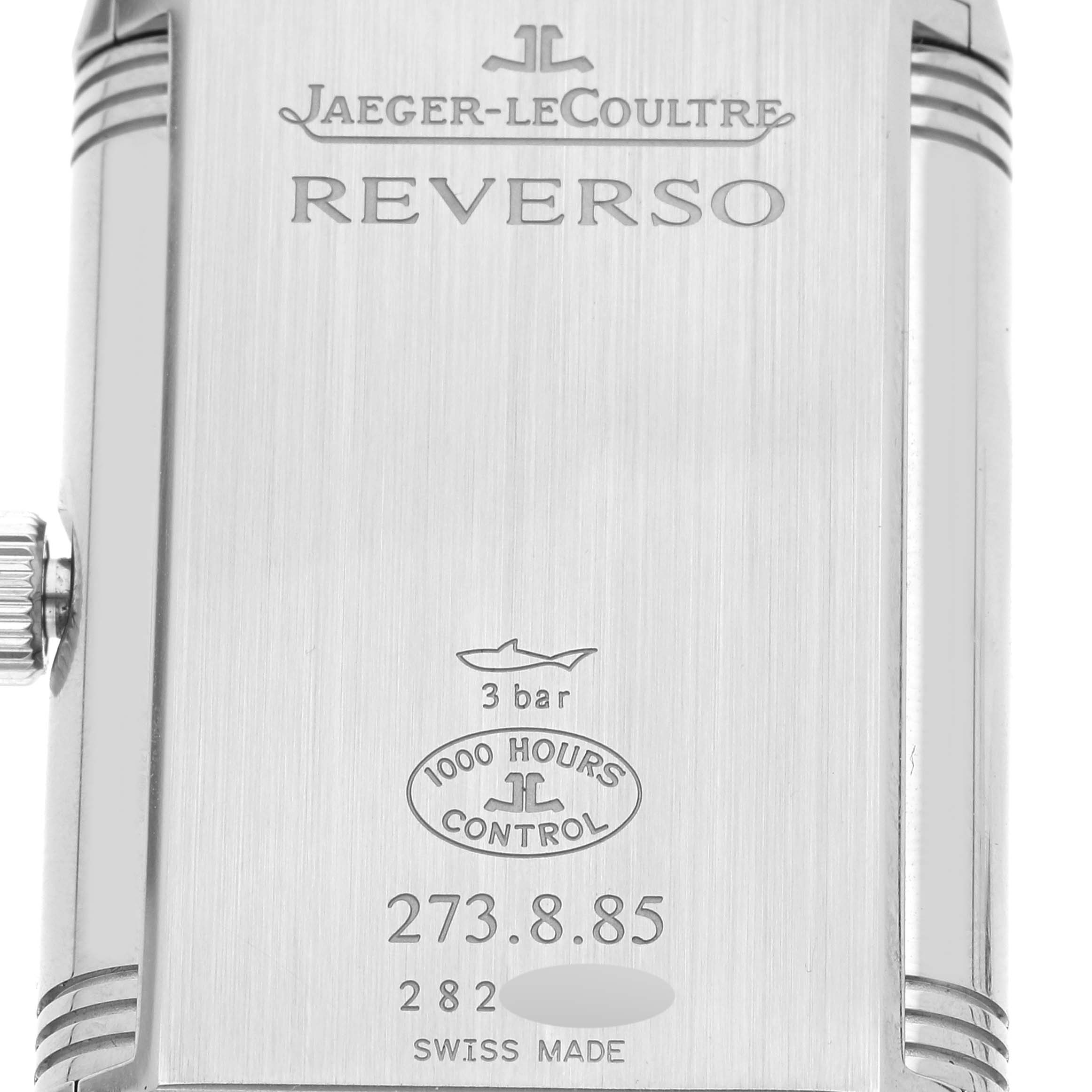 This is a close-up of the back case of a Jaeger-LeCoultre Reverso watch, displaying model information and branding.