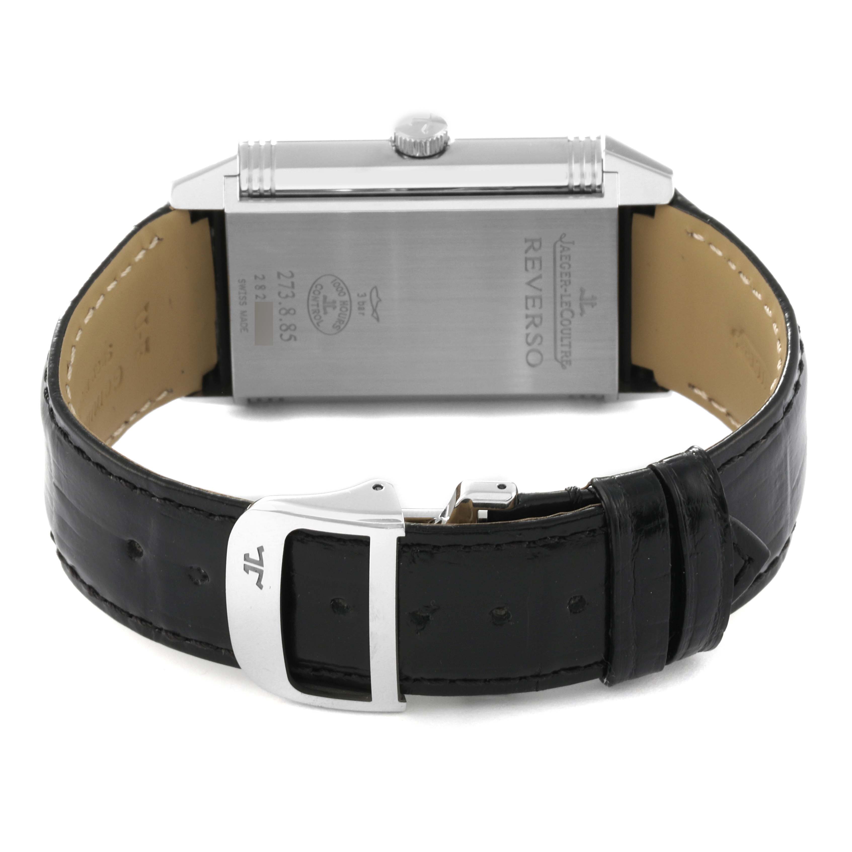 The image shows the back, crown, and leather strap of a Jaeger-LeCoultre Reverso watch.
