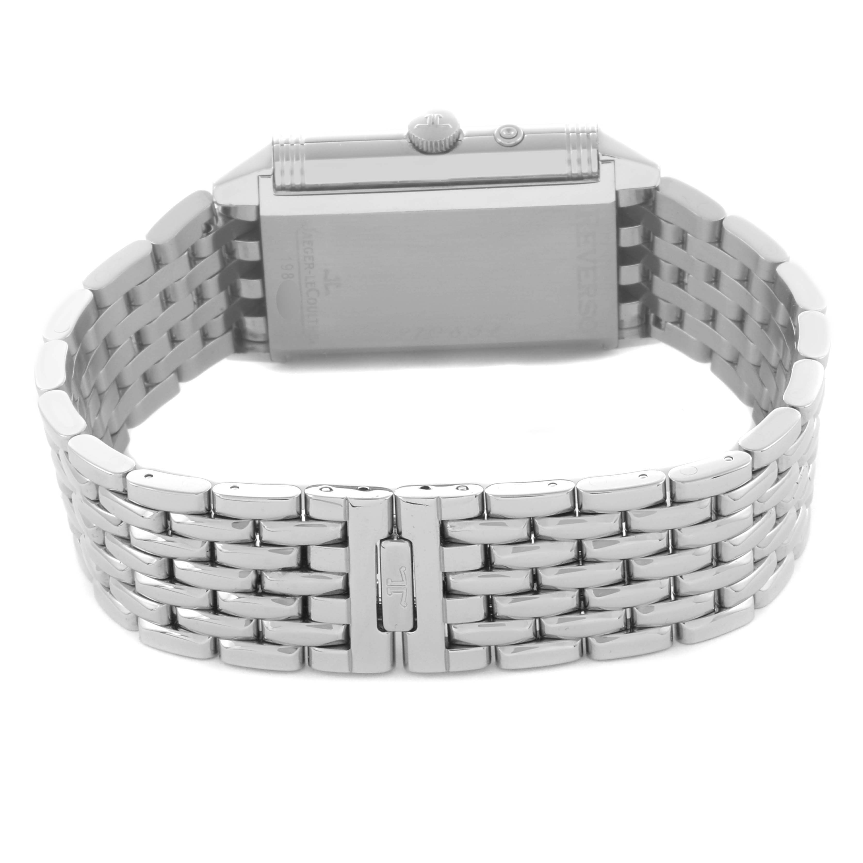 The image shows the Jaeger-LeCoultre Reverso watch from the back, highlighting its stainless steel bracelet and clasp.