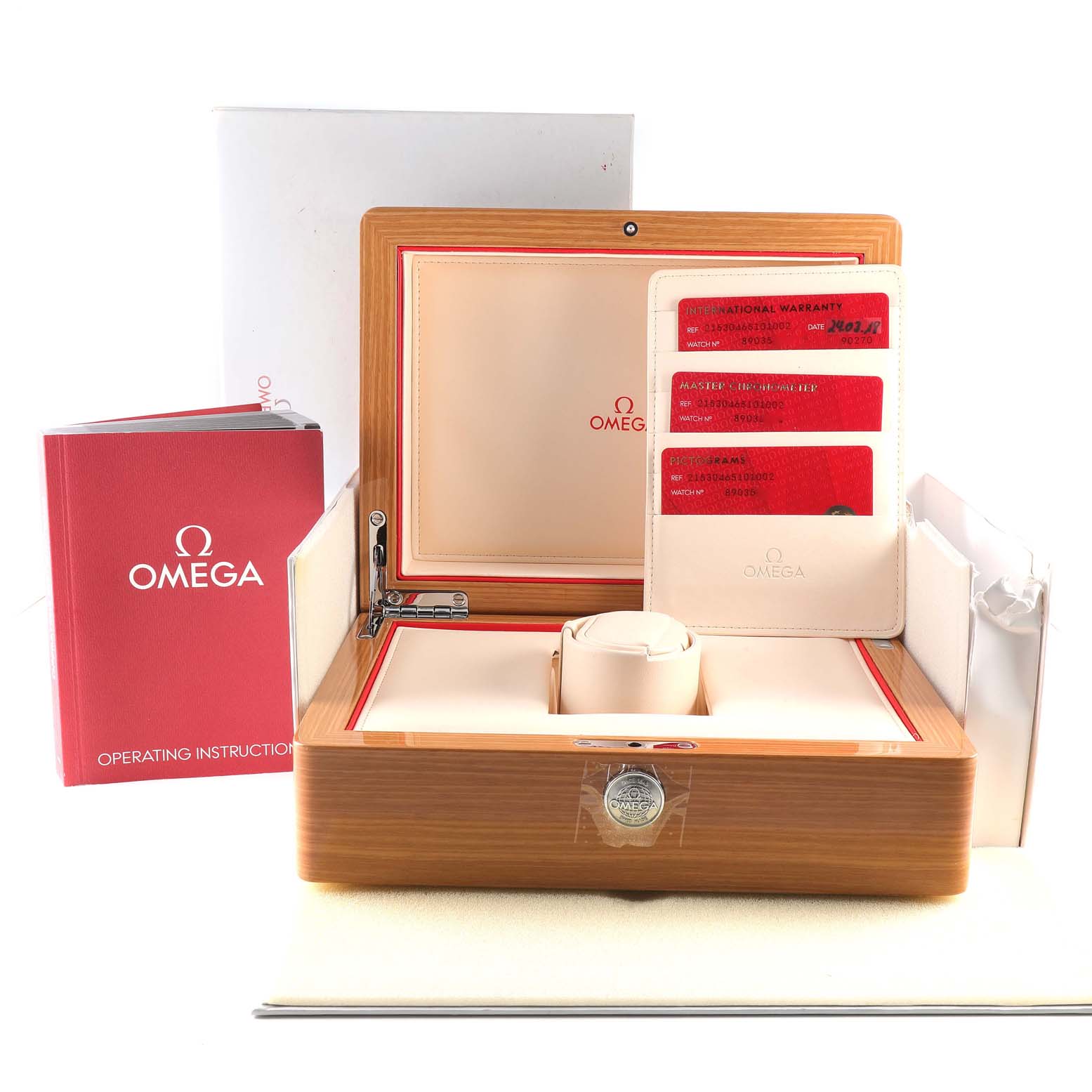 The image shows an Omega Planet Ocean 215.30.46.51.01.002 Men
s Stainless Steel Black Dial 215.30.46.51.01.002 Men
s Stainless Steel Black Dial watch box, warranty cards, and operating instructions, viewed from the front.