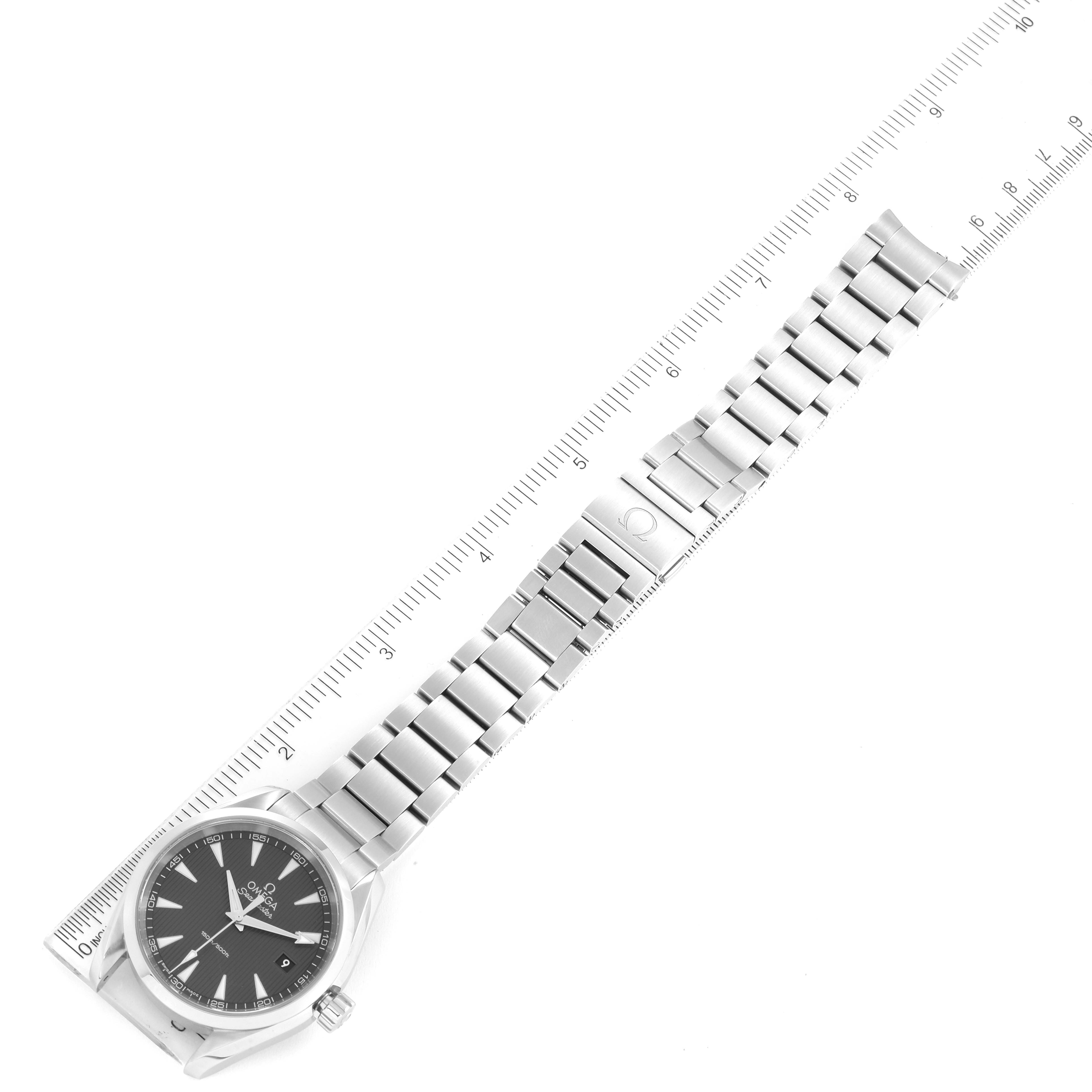 The image shows an Omega Aqua Terra 231.10.39.60.06.001 Men
s Stainless Steel Grey Dial 231.10.39.60.06.001 Men
s Stainless Steel Grey Dial watch positioned alongside a ruler, displaying the dial, bracelet, and clasp in a flat, overhead view.