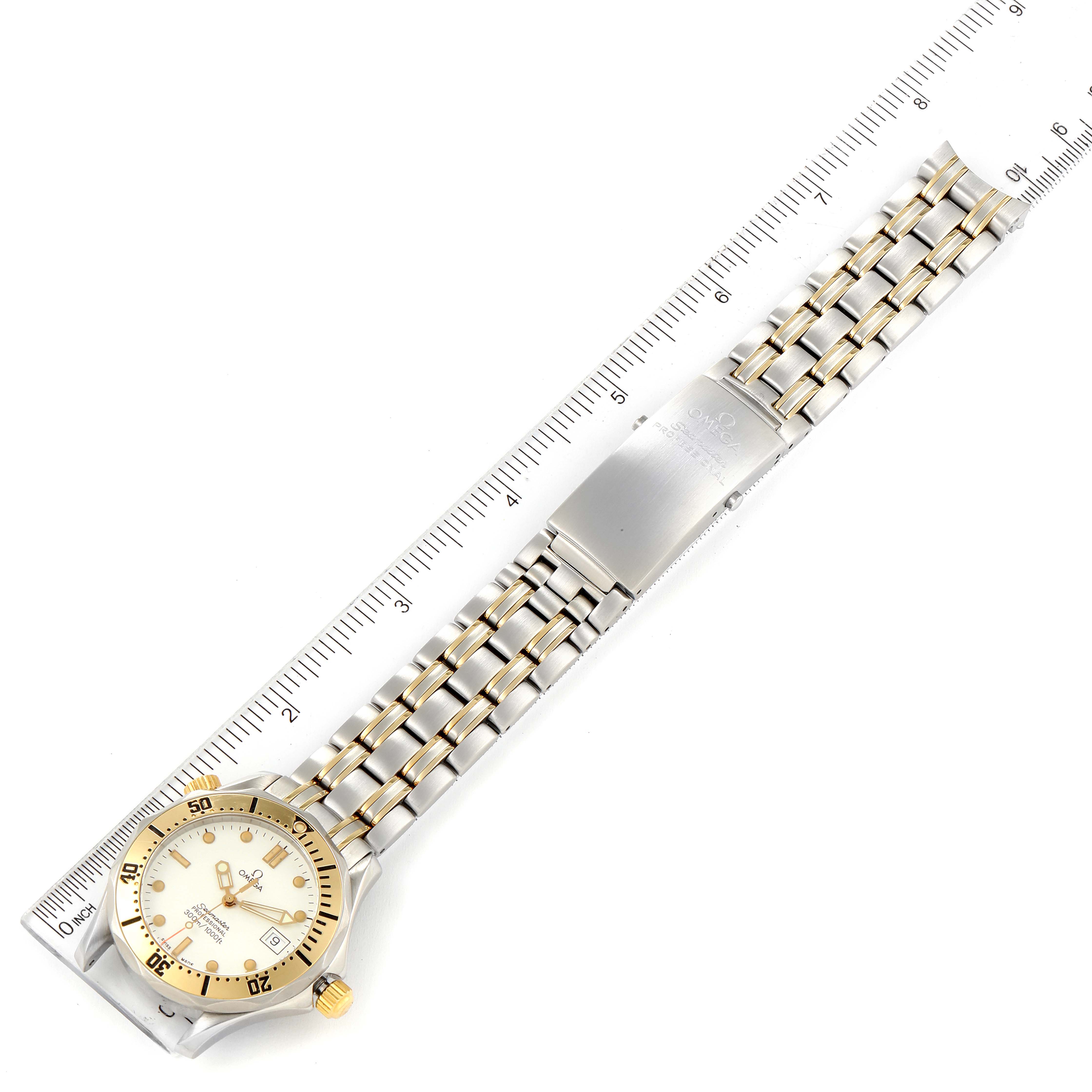 The image shows the full face and bracelet of the Omega Seamaster 2342.20.00 Men's Steel and Gold (two tone) White Dial 2342.20.00 Men's Steel and Gold (two tone) White Dial watch, laid flat next to a ruler.