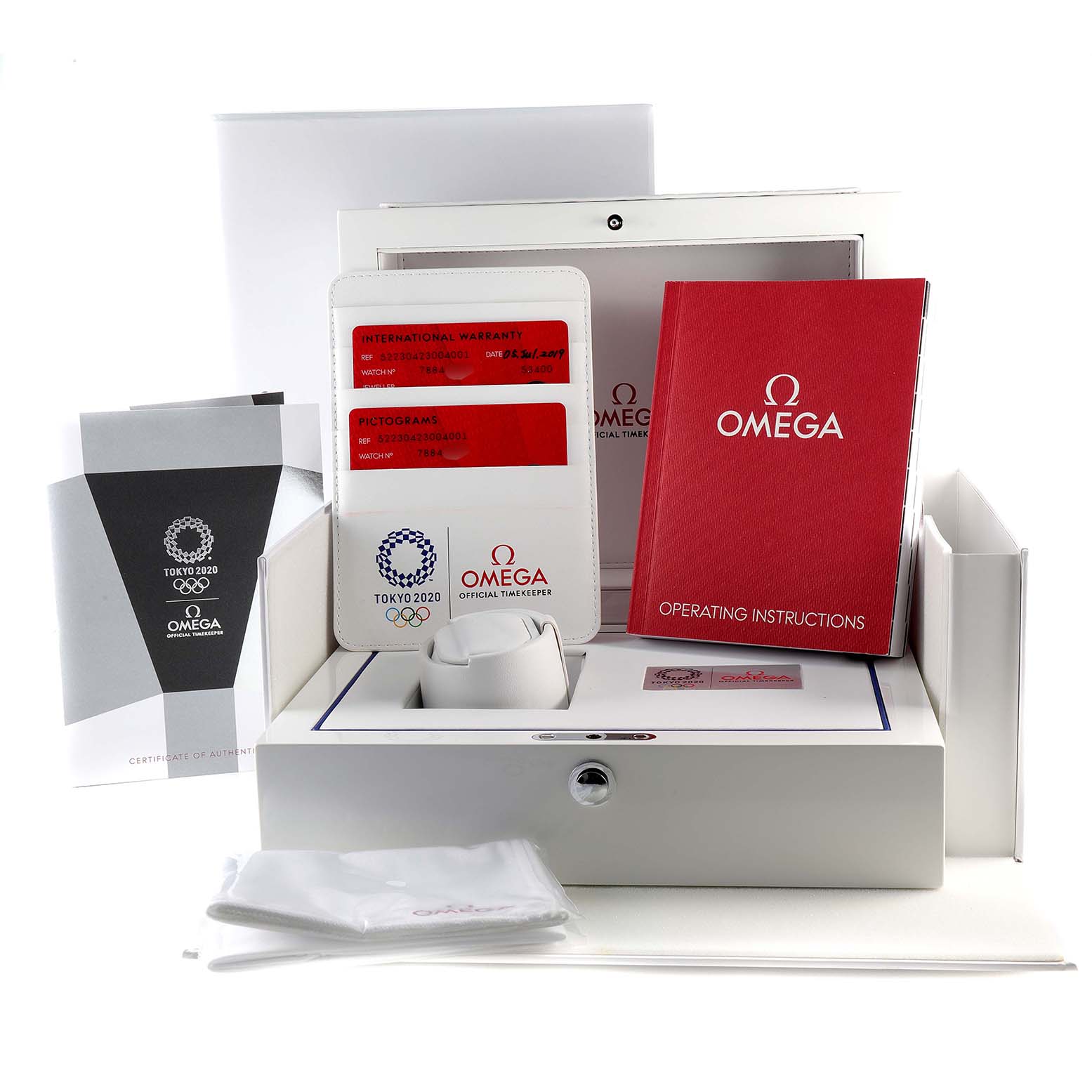 The image shows the packaging and accessories for an Omega Speedmaster 522.30.42.30.04.001 Men's Stainless Steel White Dial 522.30.42.30.04.001 Men's Stainless Steel White Dial watch, including manuals, warranty card, and certificate of authenticity.