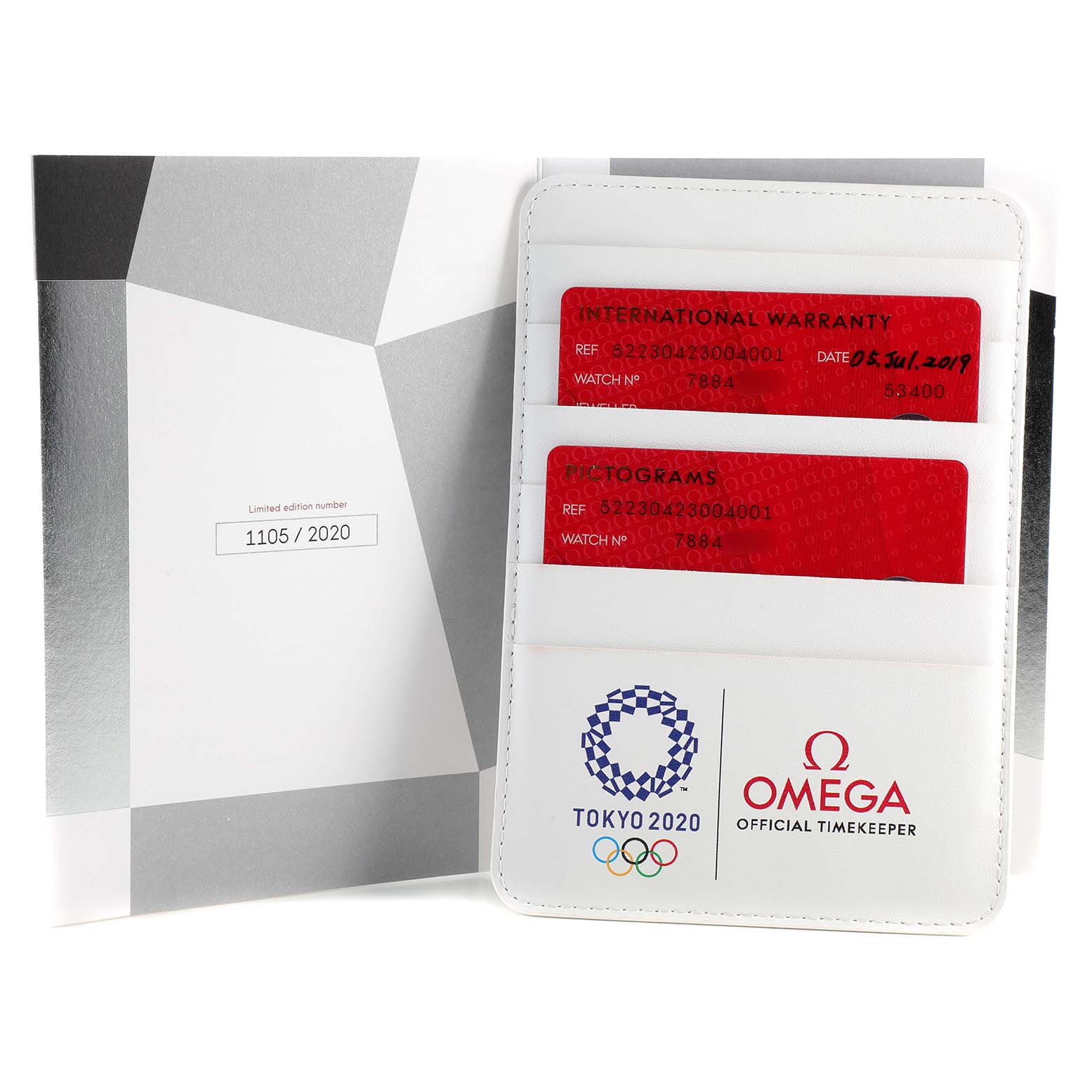 The image shows the international warranty and pictograms for the Omega Speedmaster 522.30.42.30.04.001 Men's Stainless Steel White Dial 522.30.42.30.04.001 Men's Stainless Steel White Dial, along with a document holder featuring the Tokyo 2020 and Omega logos.