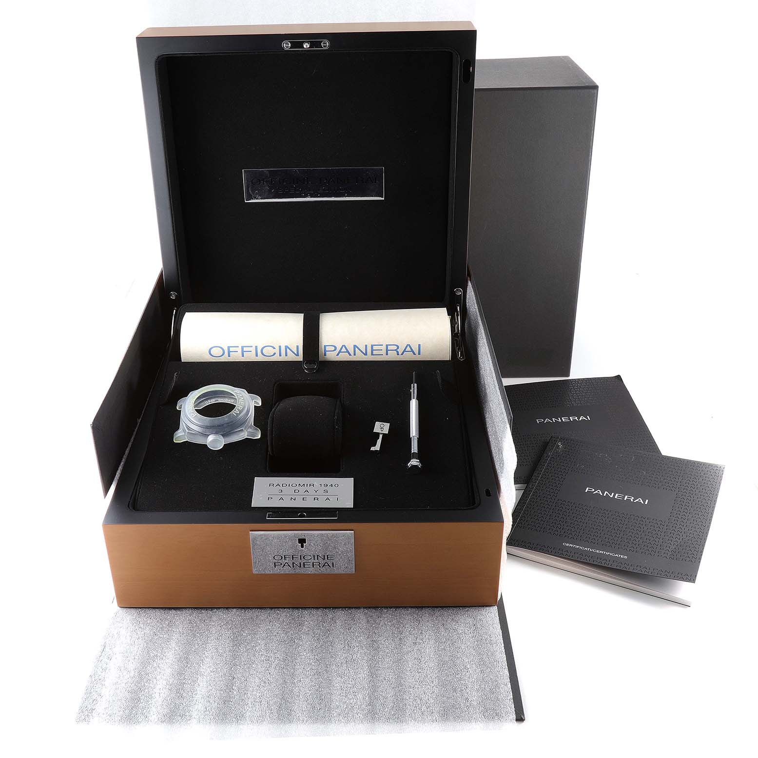 The image shows the packaging and accessories of a Panerai Radiomir PAM00790 Men's Stainless Steel Black Dial PAM00790 Men's Stainless Steel Black Dial watch, including the watch box, tool kit, manuals, and protective padding.