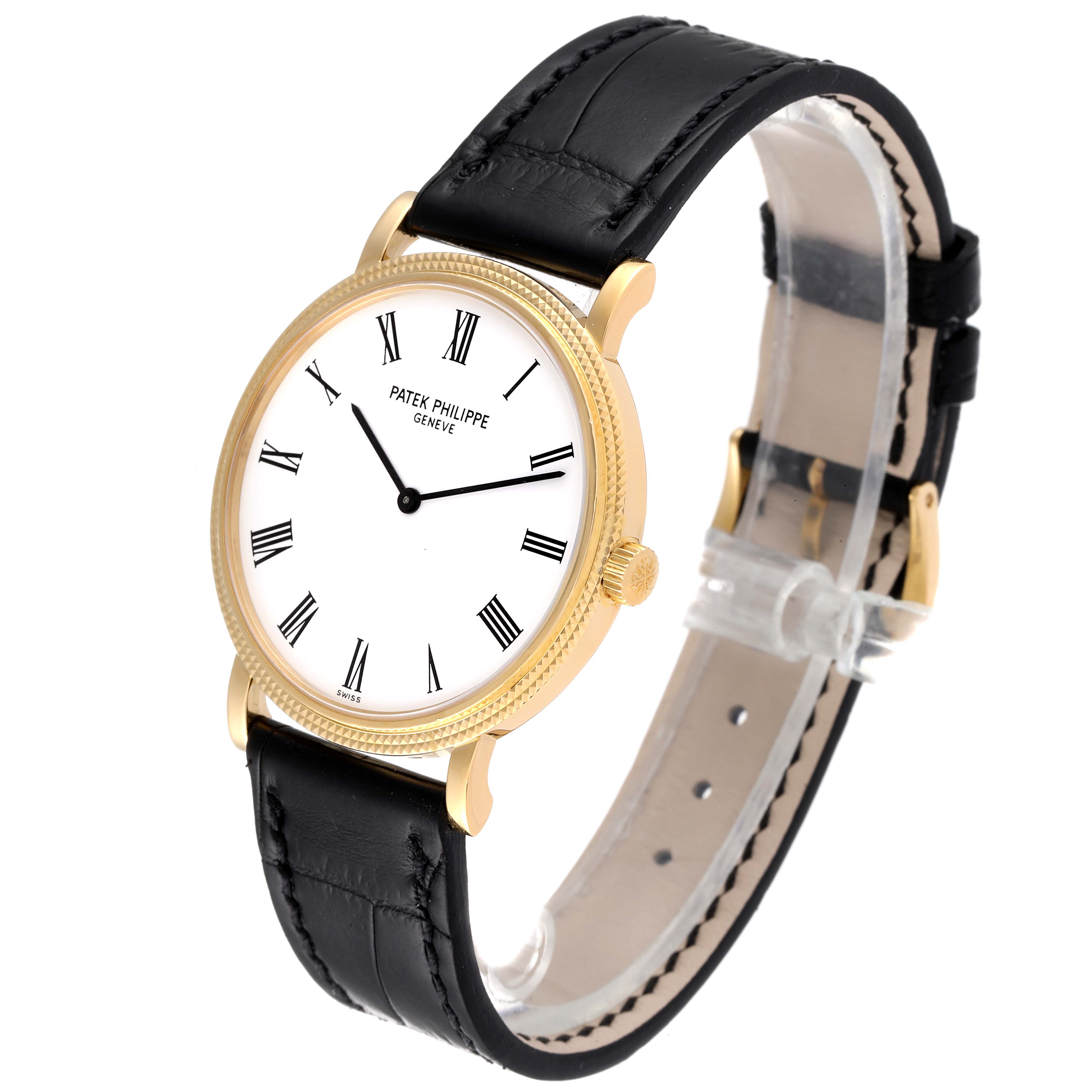 The image shows a Patek Philippe Calatrava 5120J Men's Yellow Gold White Dial 5120J Men's Yellow Gold White Dial model watch at a three-quarter angle, highlighting its black leather strap and gold case.