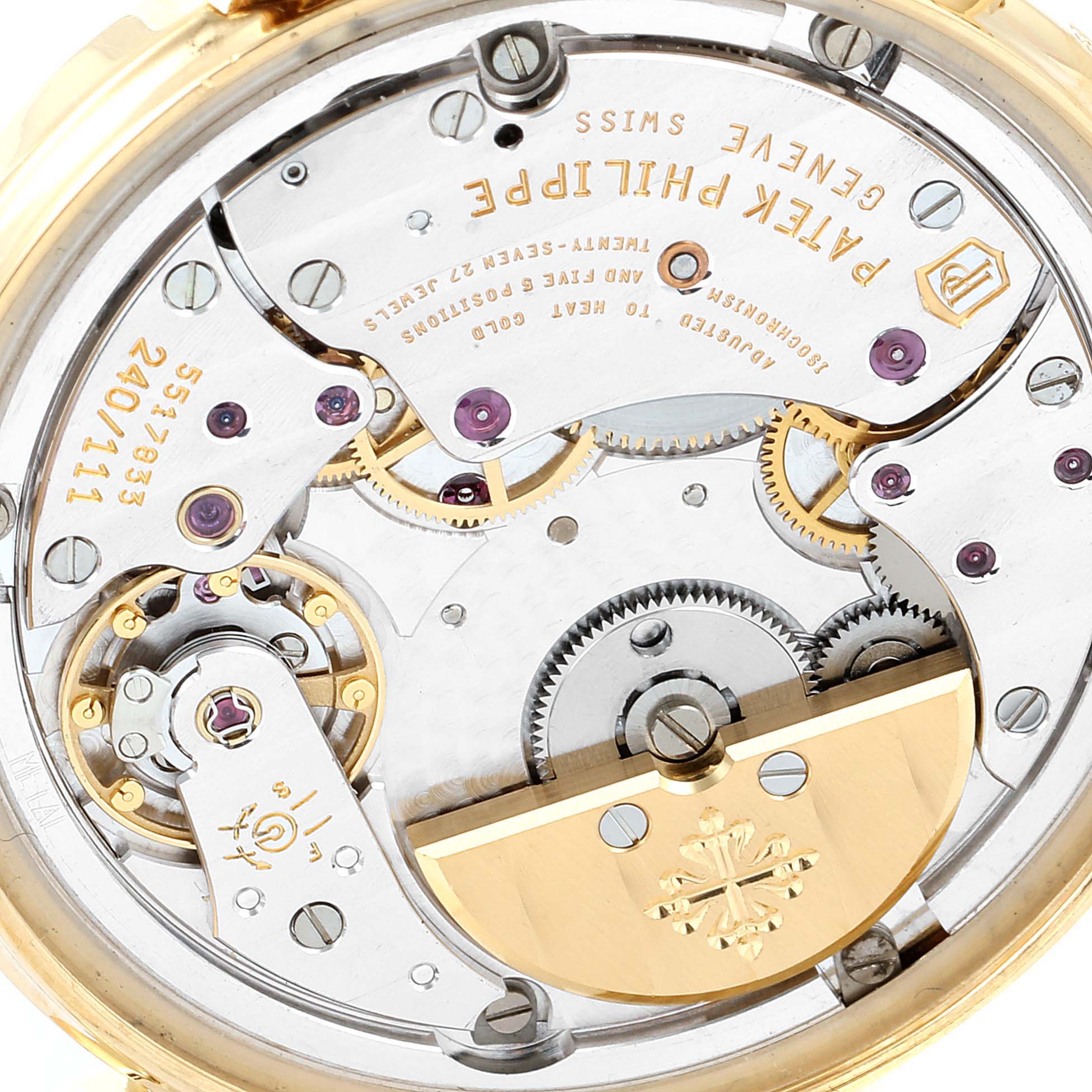 This image shows the back view of a Patek Philippe Calatrava 5120J Men's Yellow Gold White Dial 5120J Men's Yellow Gold White Dial watch, highlighting its intricate movement mechanism.