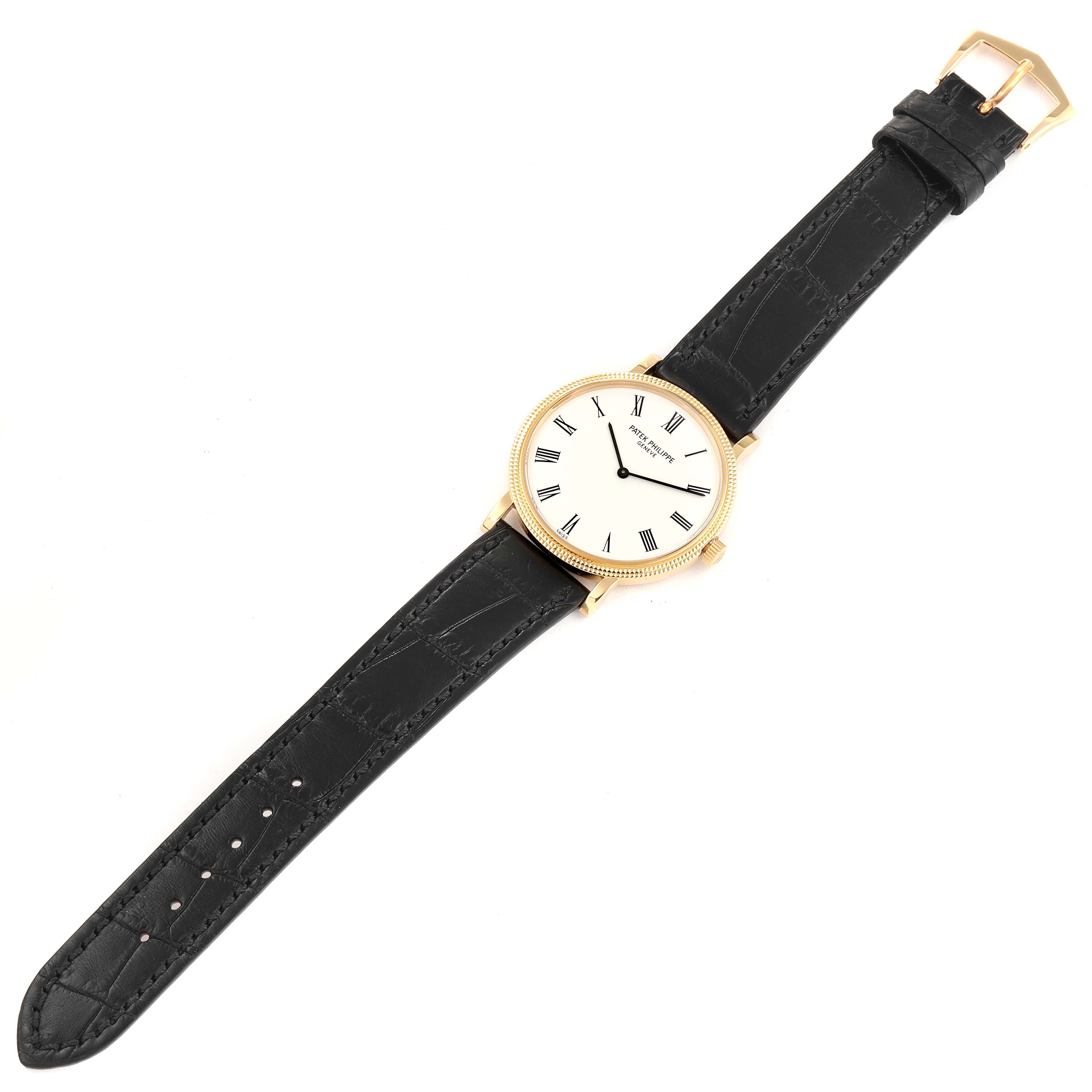 The image shows a Patek Philippe Calatrava 5120J Men's Yellow Gold White Dial 5120J Men's Yellow Gold White Dial watch laid out flat, displaying the face, black leather strap, and gold buckle.