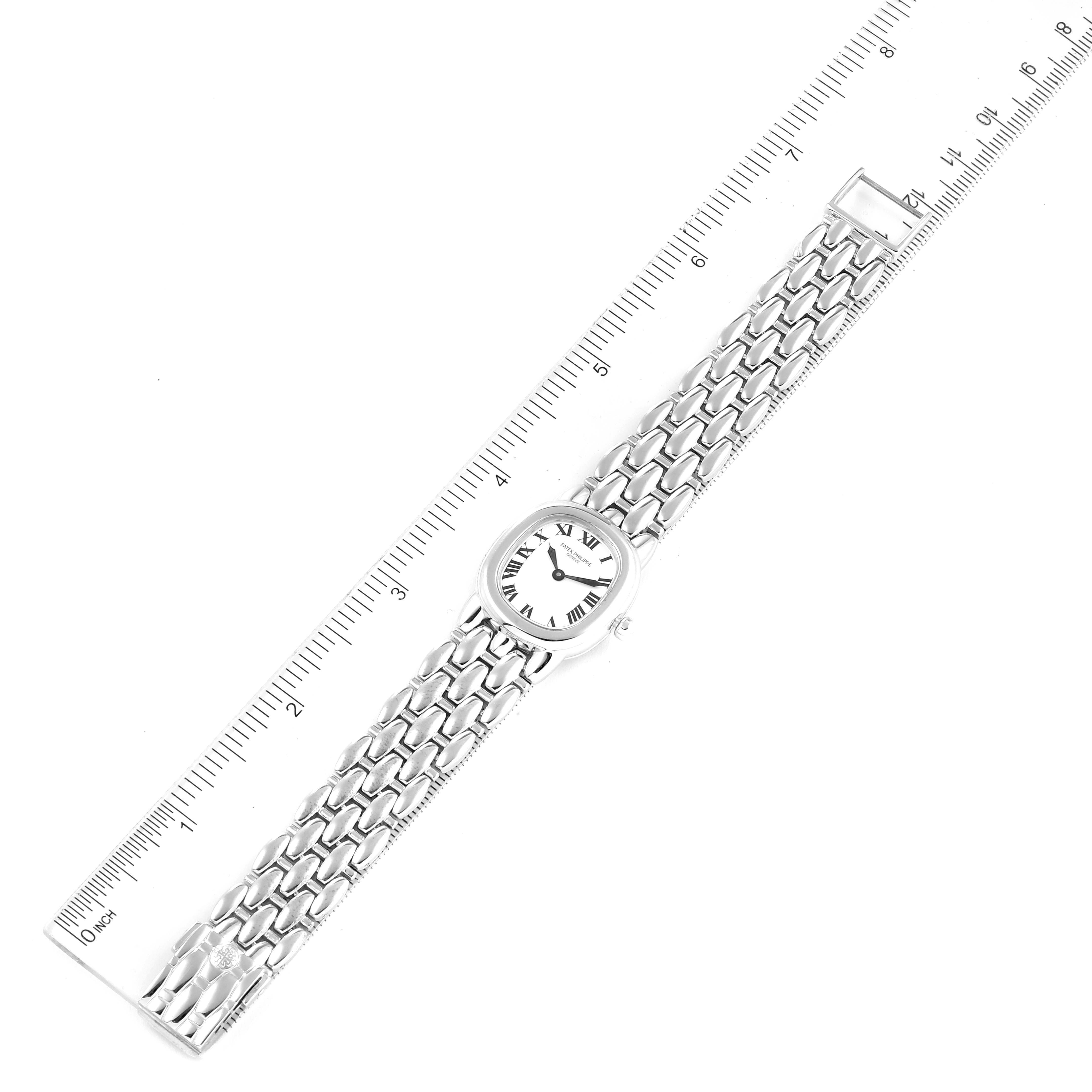 The image shows a top-down view of a Patek Philippe Golden Ellipse 4830G Women's White Gold White Dial 4830G Women's White Gold White Dial watch with a ruler for scale.