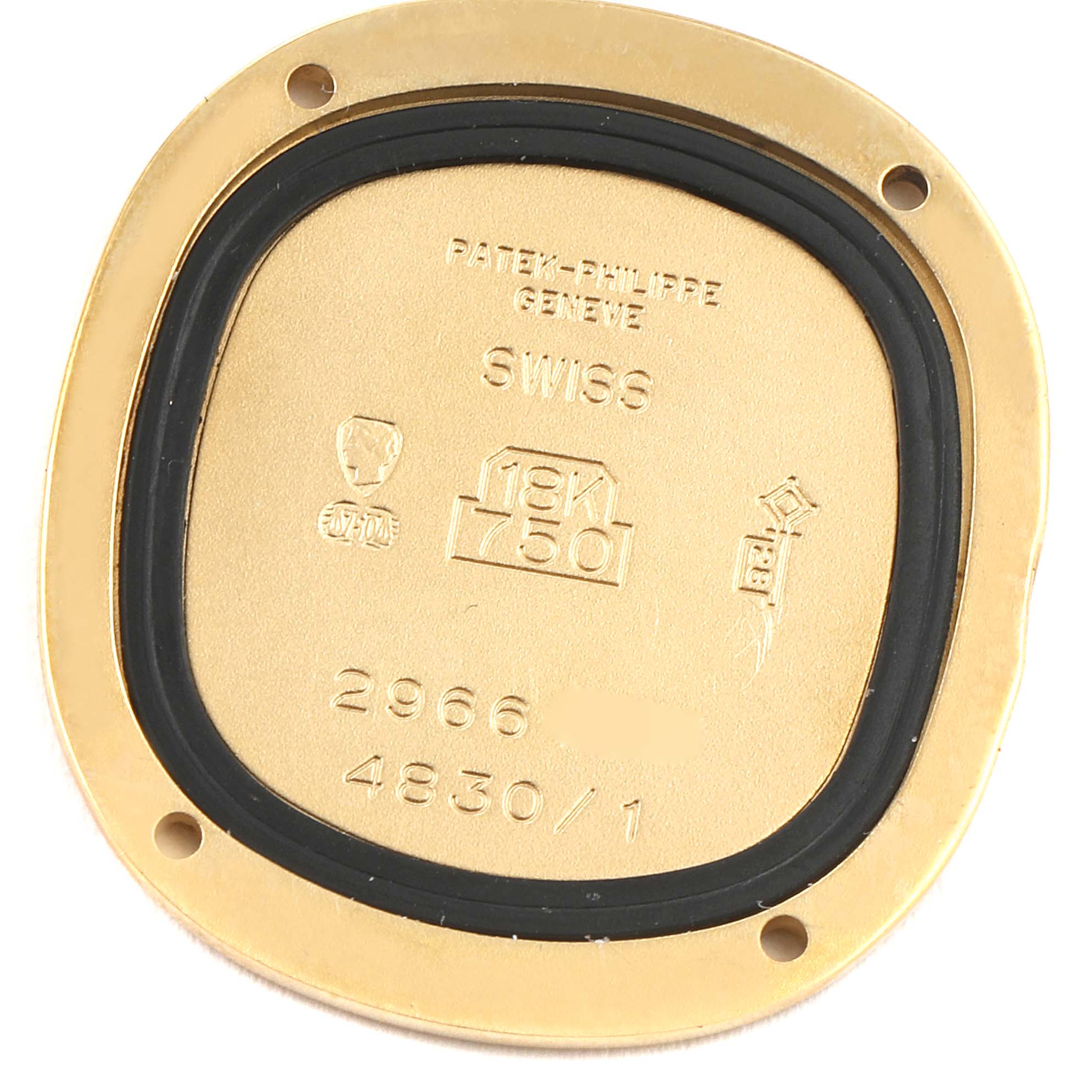 The image shows the back case of a Patek Philippe Golden Ellipse 4830J Women's Yellow Gold White Dial 4830J Women's Yellow Gold White Dial watch, highlighting its engraving and markings.