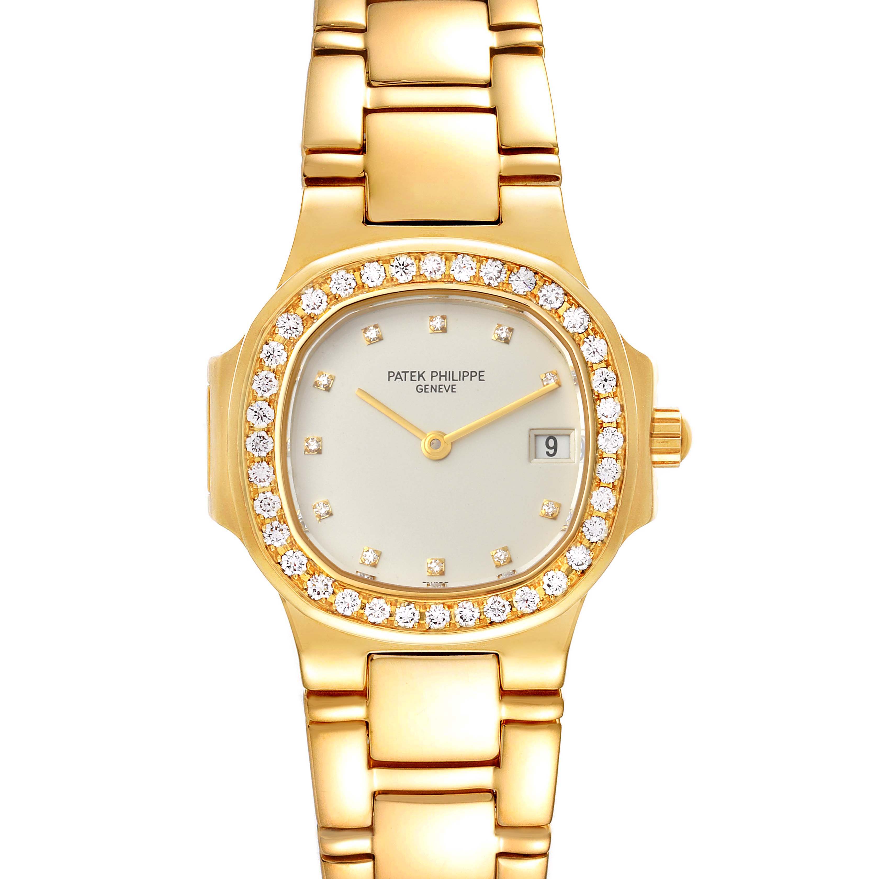 The Patek Philippe Nautilus 4700/530 Women's Yellow Gold Beige Dial 4700/530 Women's Yellow Gold Beige Dial watch is shown from a top-down angle, displaying the dial, bezel, and bracelet.
