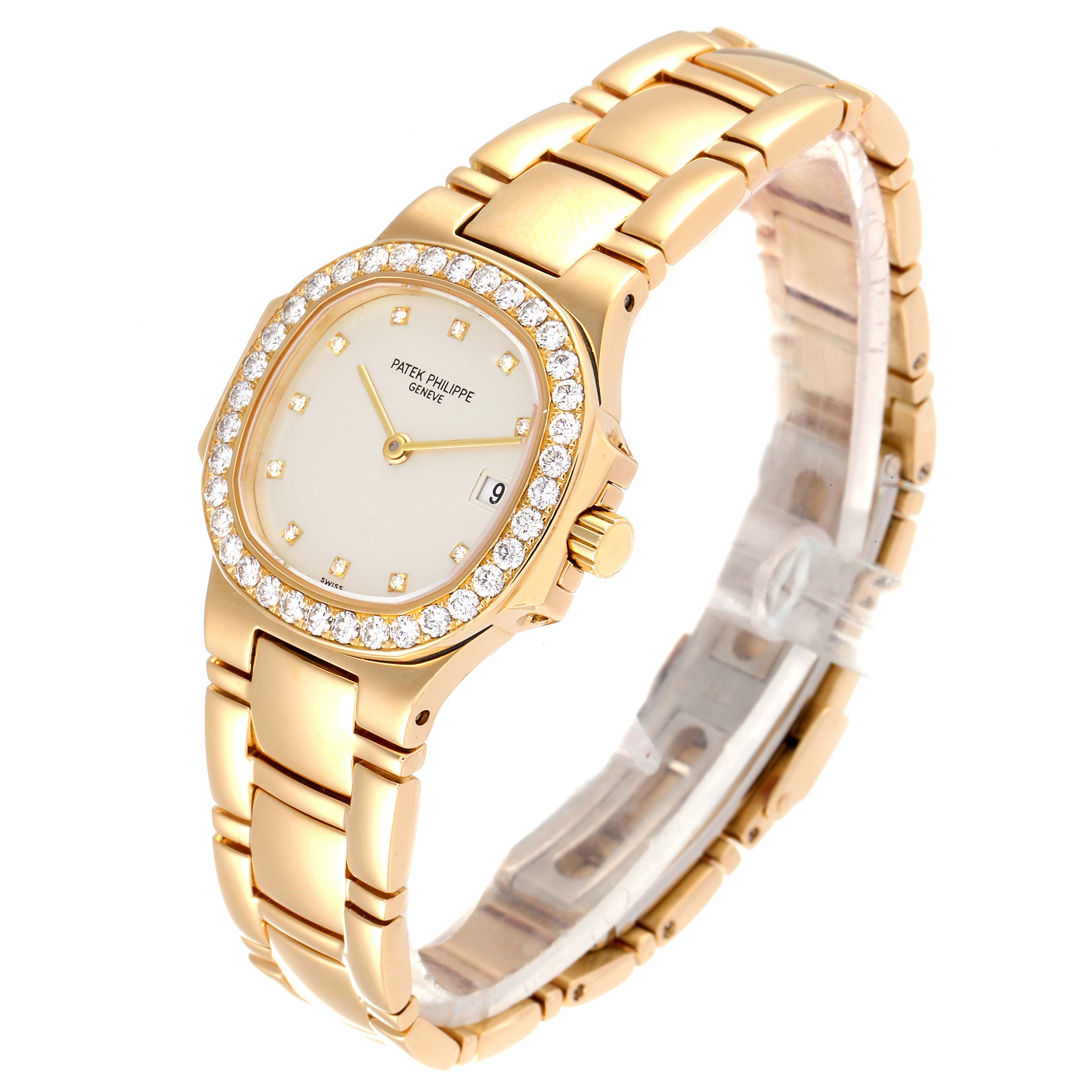 This image shows a gold Patek Philippe Nautilus 4700/530 Women's Yellow Gold Beige Dial 4700/530 Women's Yellow Gold Beige Dial watch at a slight angle, highlighting the diamond-encrusted bezel, face, and bracelet.