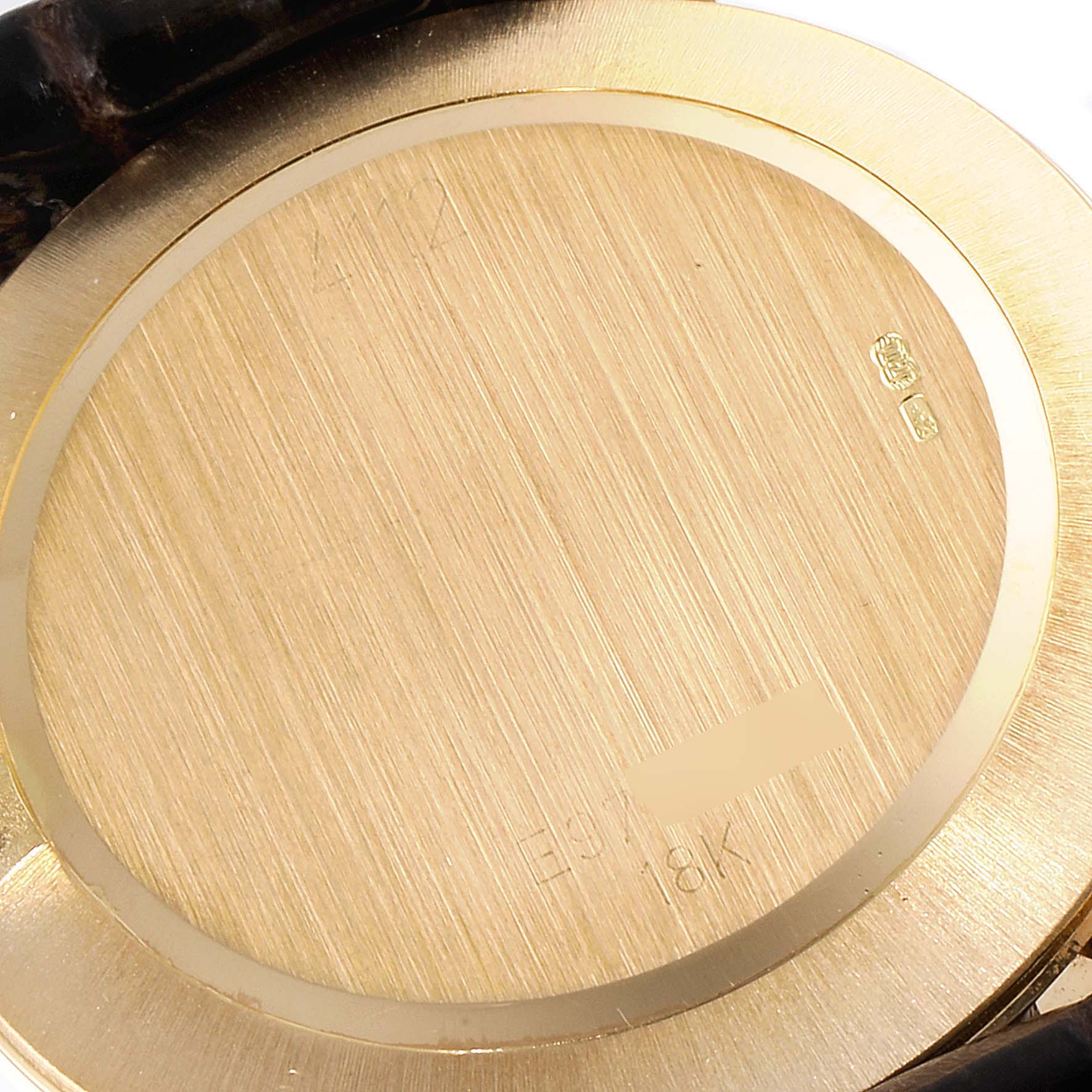 This image shows the caseback of a Rolex Cellini 4112 Men's Yellow Gold Champagne Dial 4112 Men's Yellow Gold Champagne Dial watch, focusing on the brushed gold finish and hallmark markings.