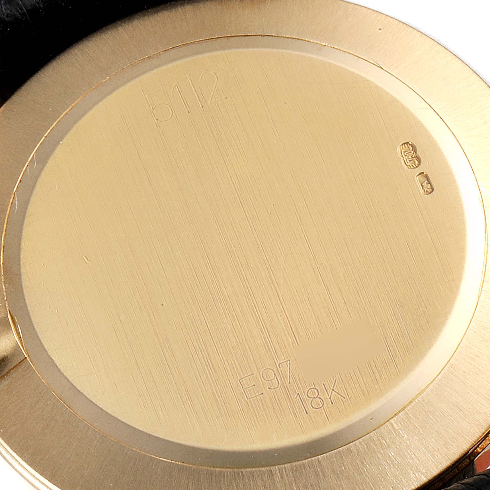 The image shows the back case of a Rolex Cellini 5112 Men's Yellow Gold Champagne Dial 5112 Men's Yellow Gold Champagne Dial watch, highlighting the engraved model number and 18K gold marking.