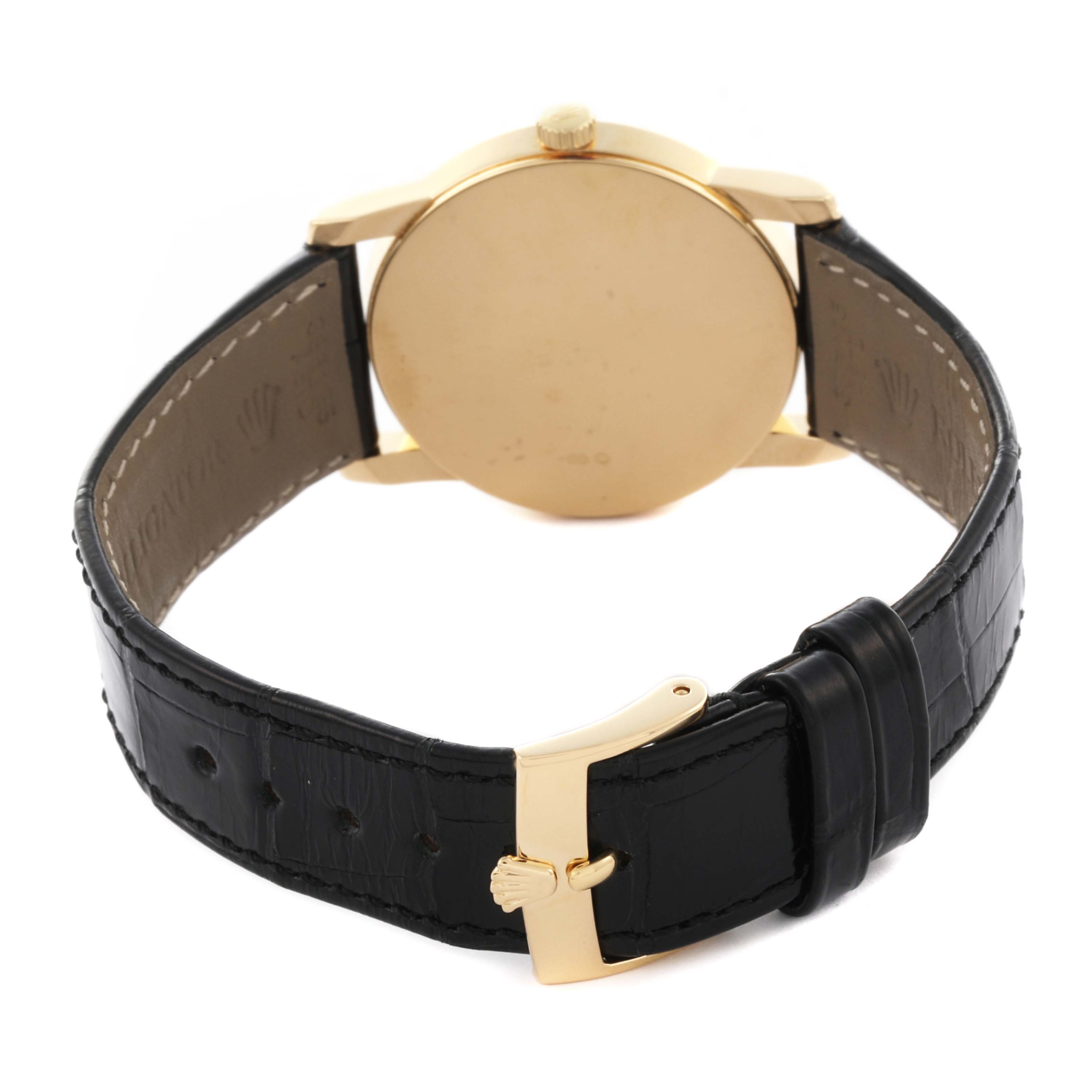 The image shows the back view of a Rolex Cellini 5116/8 Men
s Yellow Gold Champagne Dial 5116/8 Men
s Yellow Gold Champagne Dial watch, highlighting the case, crown, and clasp with a leather strap.