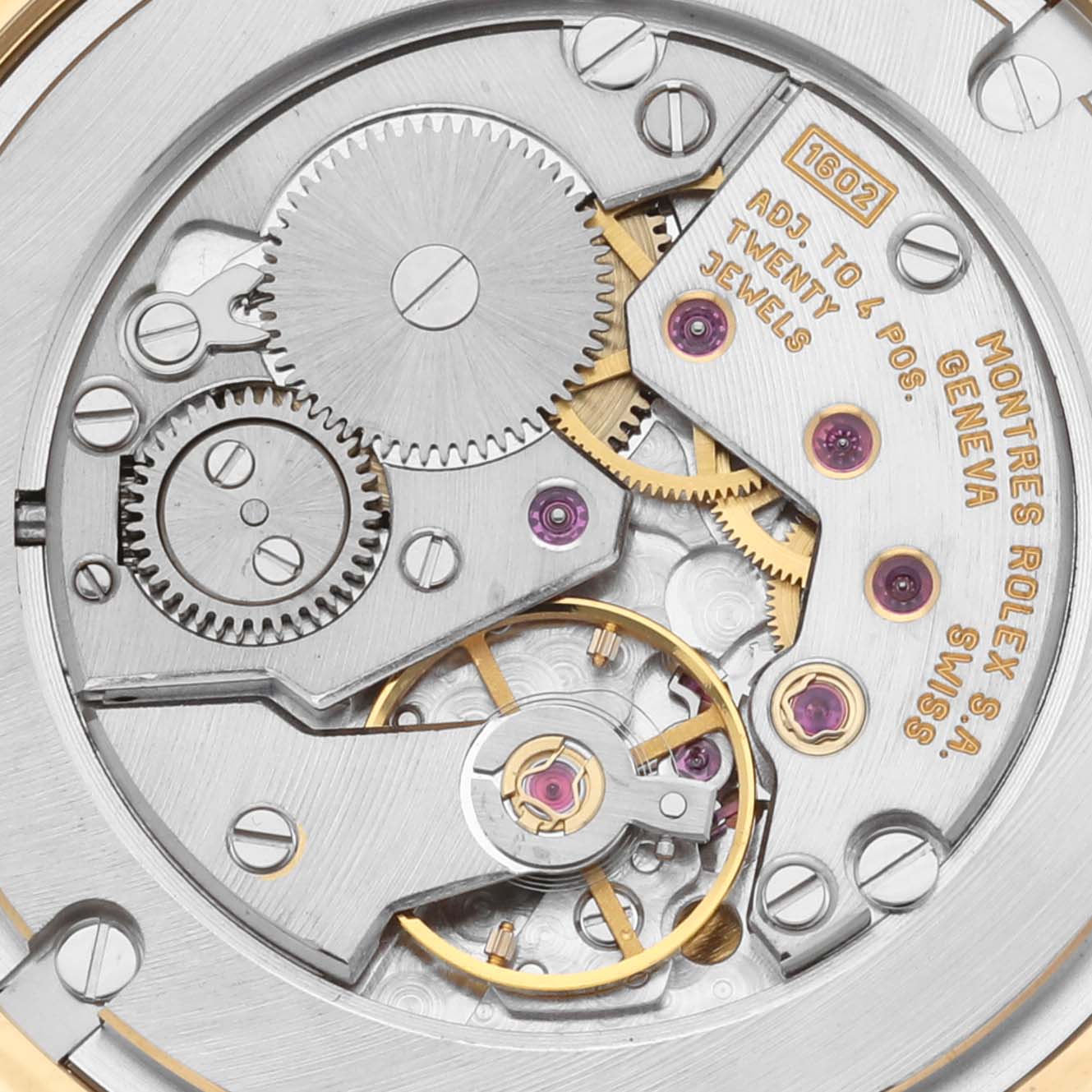 The image shows the movement mechanism of a Rolex Cellini 5116/8 Men
s Yellow Gold Champagne Dial 5116/8 Men
s Yellow Gold Champagne Dial watch, highlighting gears and jewel details.