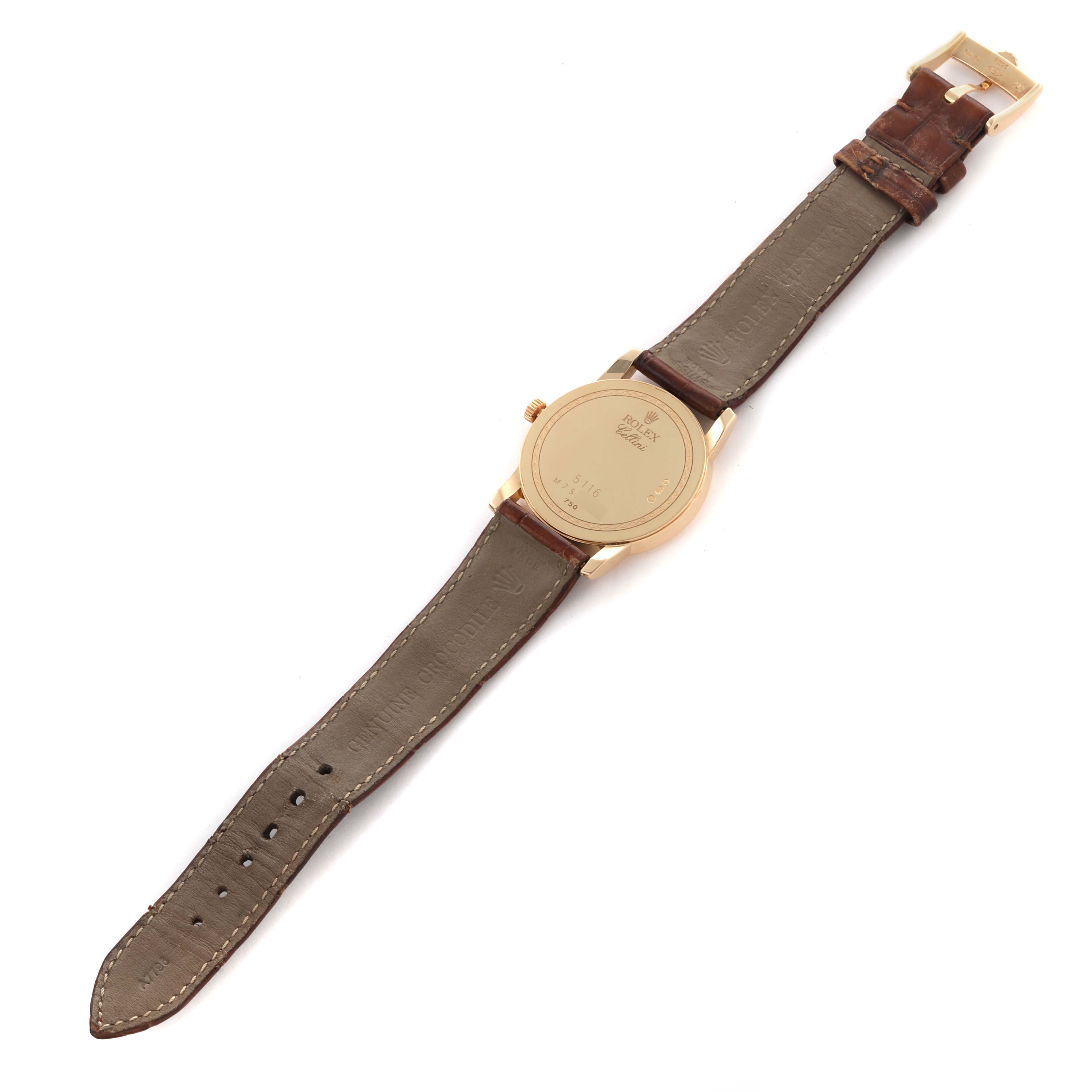 The image shows the back of a Rolex Cellini 5116/8 Men
s Yellow Gold Beige Dial 5116/8 Men
s Yellow Gold Beige Dial watch, including the case back, crown, and leather strap, from a top-down angle.