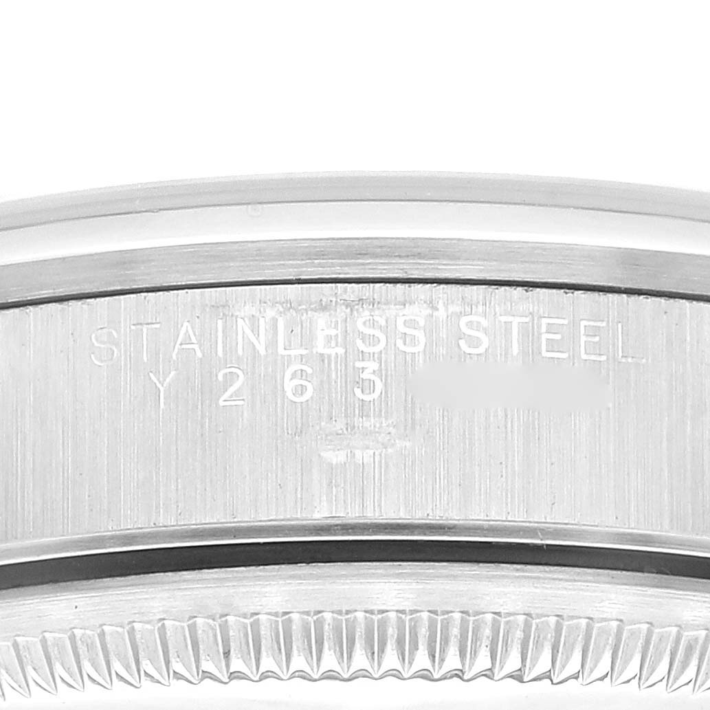 This image shows a close-up view of the stainless steel case back with engravings and the fluted bezel of a Rolex Date 15200 Men
s Stainless Steel Black Dial 15200 Men
s Stainless Steel Black Dial watch.