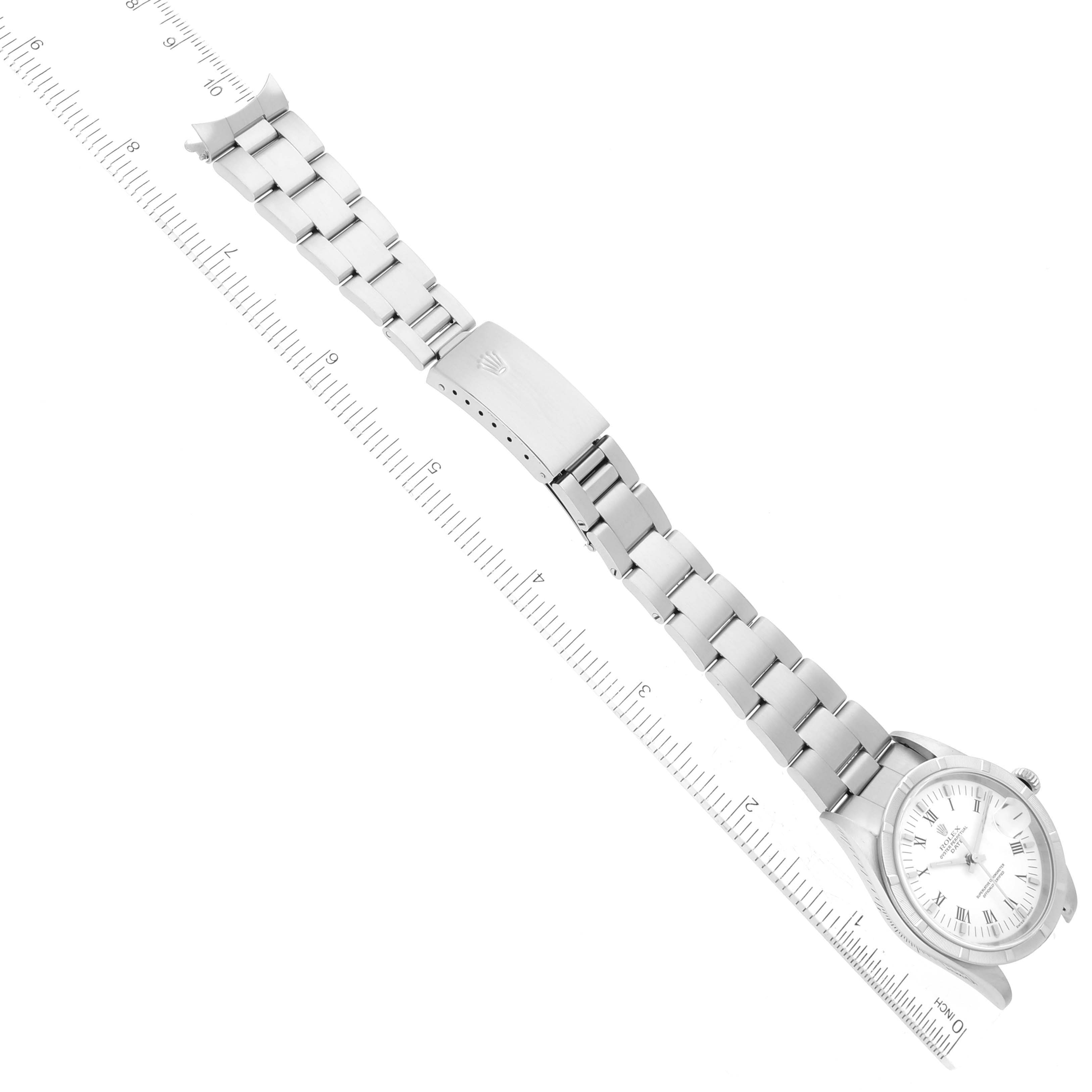 The image shows a top-down view of a Rolex Date 15210 Men's Stainless Steel White Dial 15210 Men's Stainless Steel White Dial model watch with the bracelet and clasp extended against a ruler.