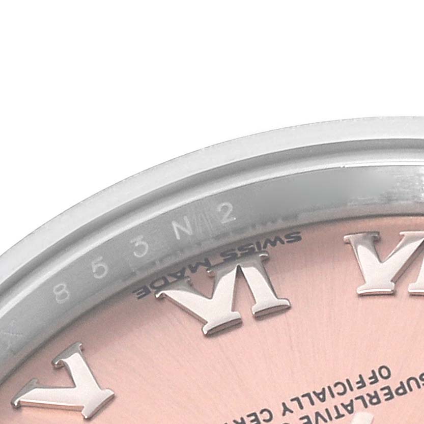 The image shows a close-up of a partial dial and bezel from a Rolex Datejust 279160 Women's Stainless Steel Pink Dial 279160 Women's Stainless Steel Pink Dial, focusing on Roman numerals and edge details.